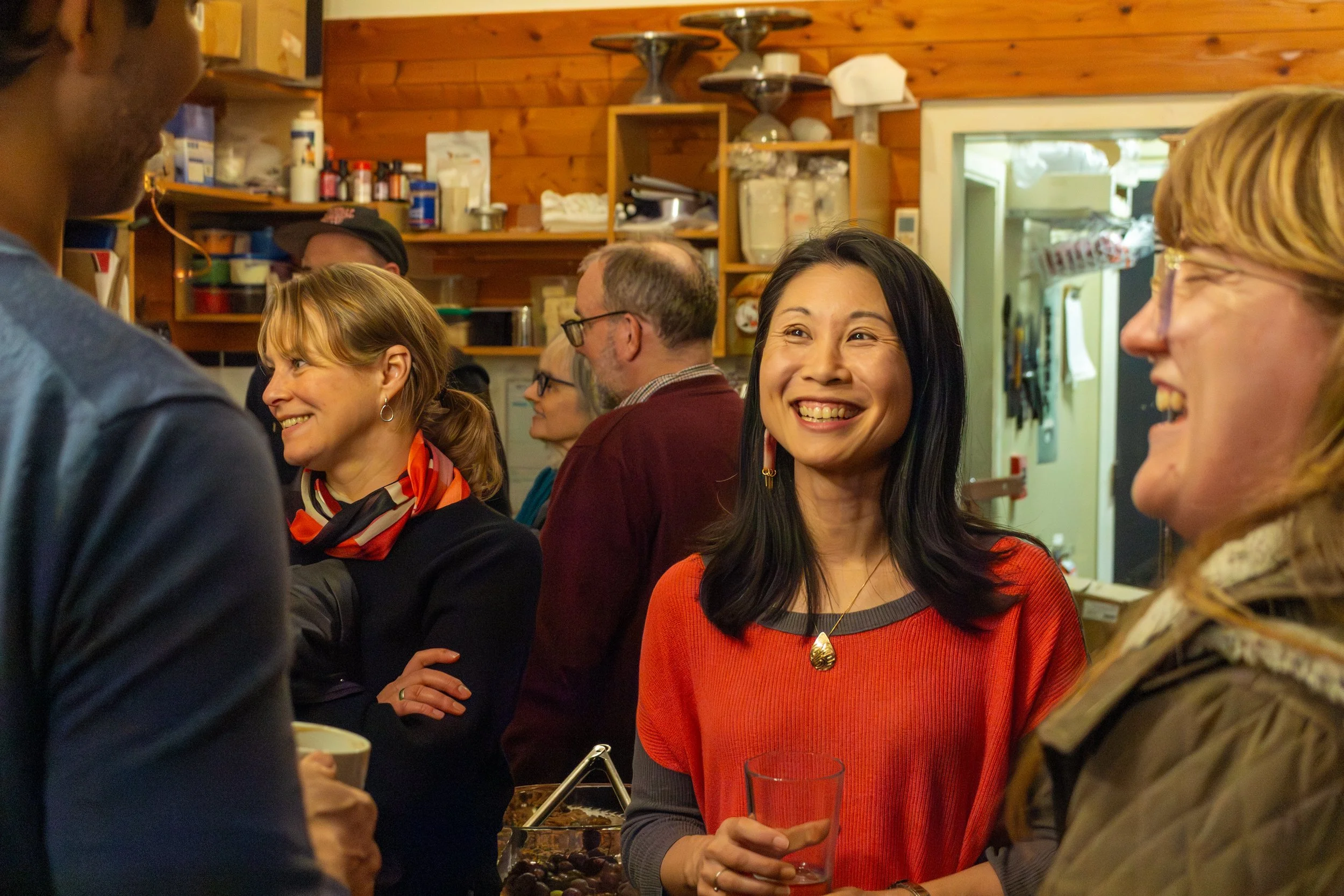 Image of Iona Bonamis engaging in conversations with other people at a community event.