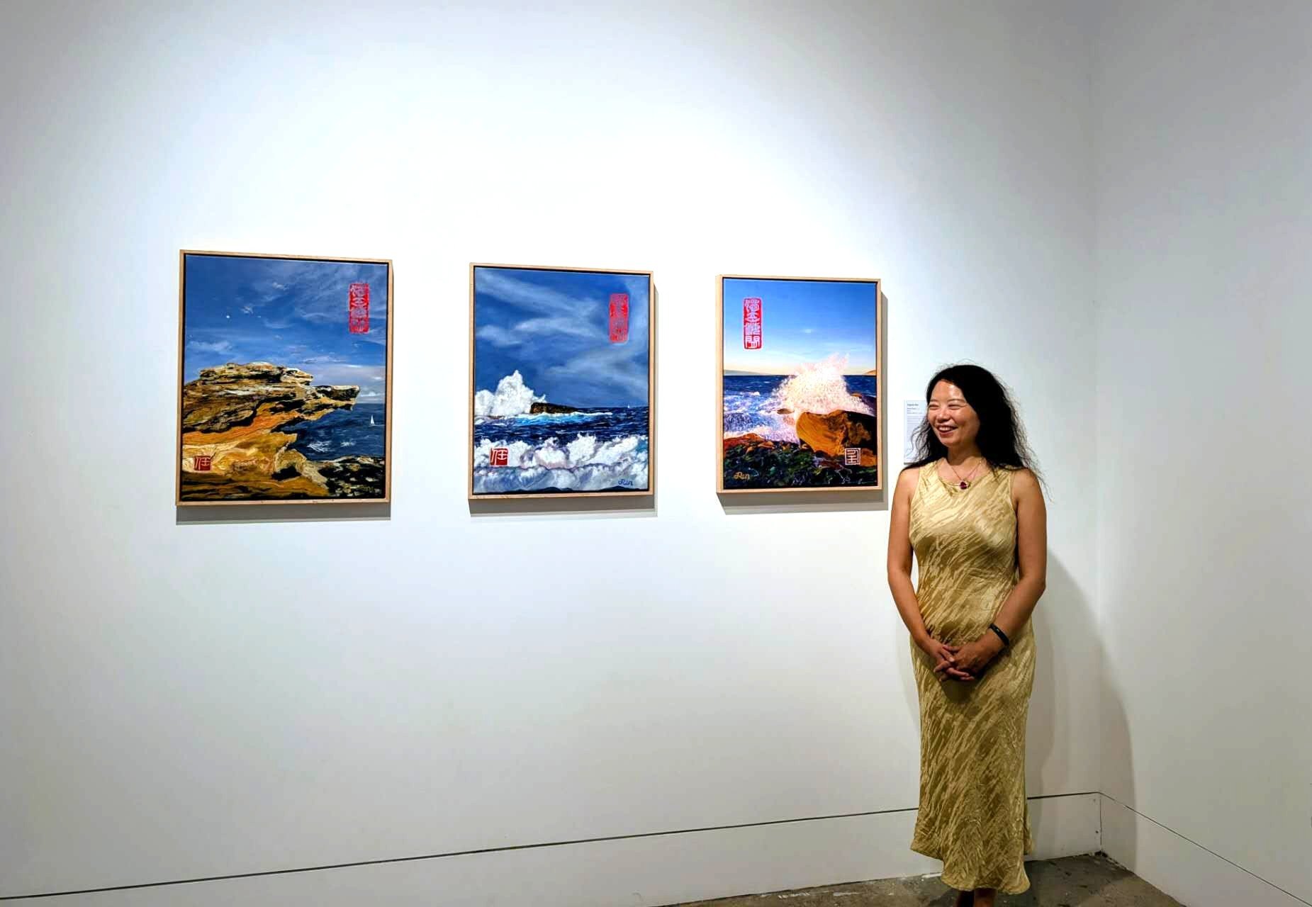 Jingmin Ren with three XINYIN LIUNIAN® – Bondi Series paintings at the Good Together exhibition, Bondi Pavilion Gallery, Sydney, 2026.