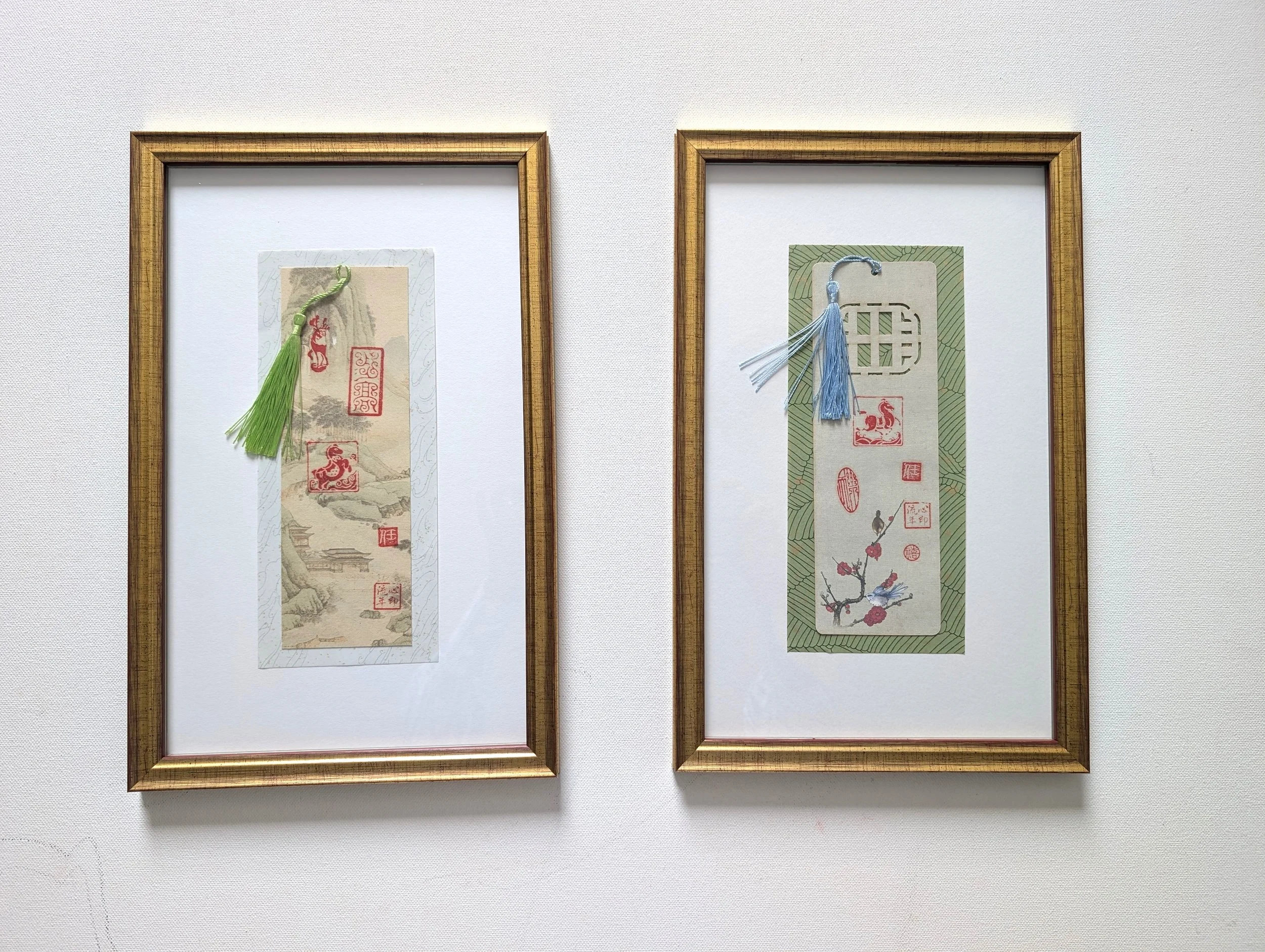Two framed XINYIN LIUNIAN® | 心印流年 bookmark artworks by Jingmin Ren 任静敏, featuring Chinese seals, botanical motifs and tassels.