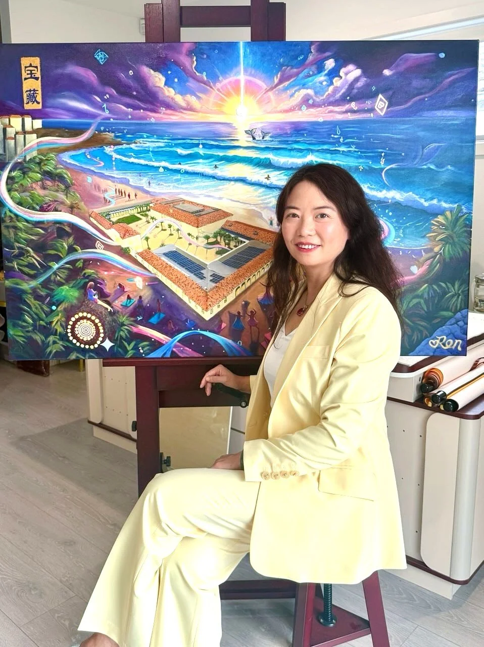 Sydney-based interdisciplinary artist and artist–researcher Jingmin Ren 任静敏 pictured with one of her paintings exploring light, nature and spiritual energy.