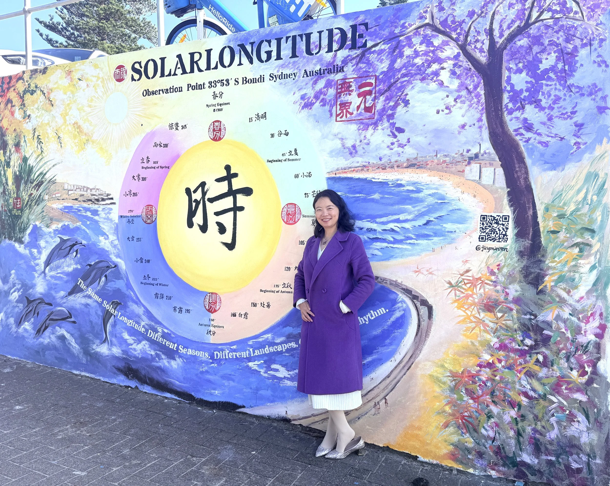 Jingmin Ren 任静敏 standing with her public artwork Solar Longitude – Time Orbit | 太阳黄经－时间轨道 at Bondi Sea Wall, Sydney, 2026.