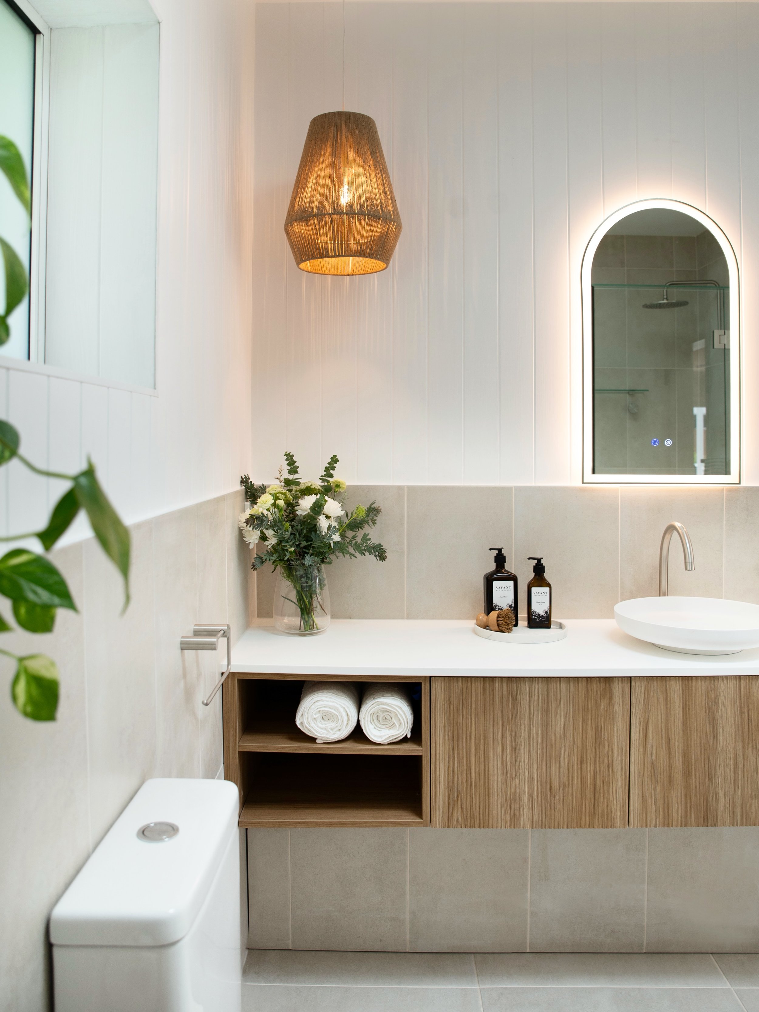 A light filled coastal sanctuary ✨
&nbsp;
Soft neutral tones, warm timber and gently curved corners create a calm, welcoming feel in our Mid-North Coast project. Natural light pours in through the skylight, while the moody pendant sets the tone for a