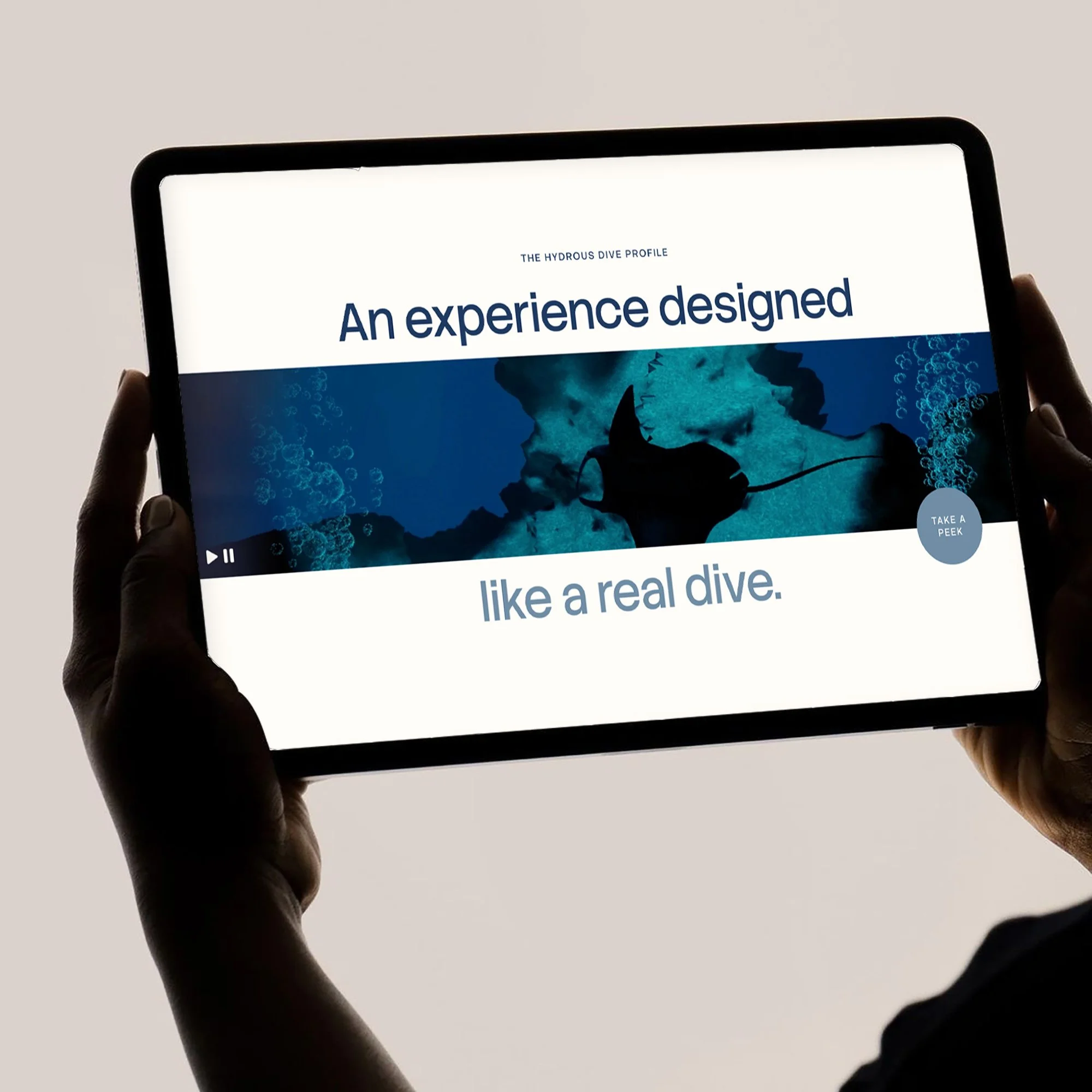 Person holding a tablet displaying a diving experience advertisement with a shark and blue tones.