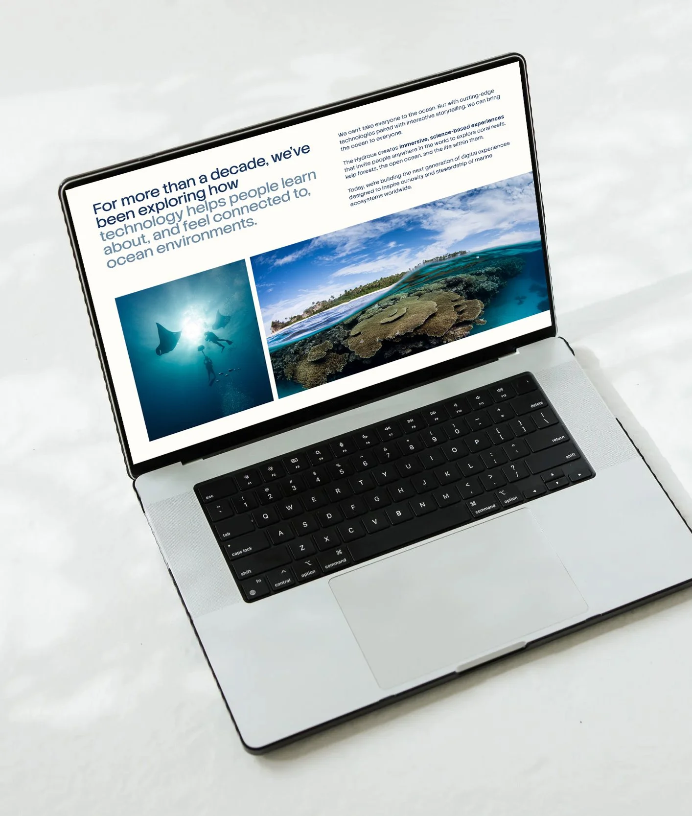 Laptop with a screen displaying a website about ocean environments, including images of divers and coral reefs.