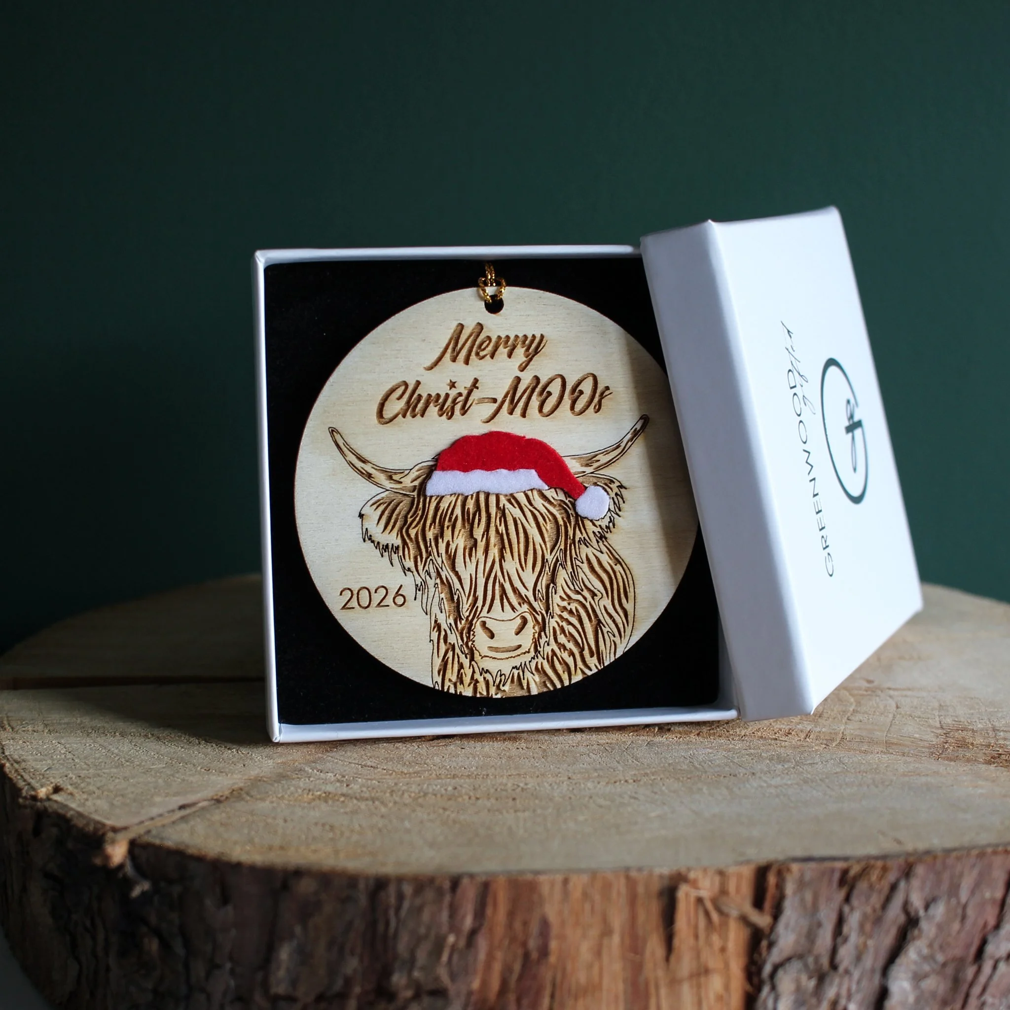 Wooden highland cow Christmas ornament with optional 2026 year engraving, presented in a white Greenwood Gifted gift box with black insert.