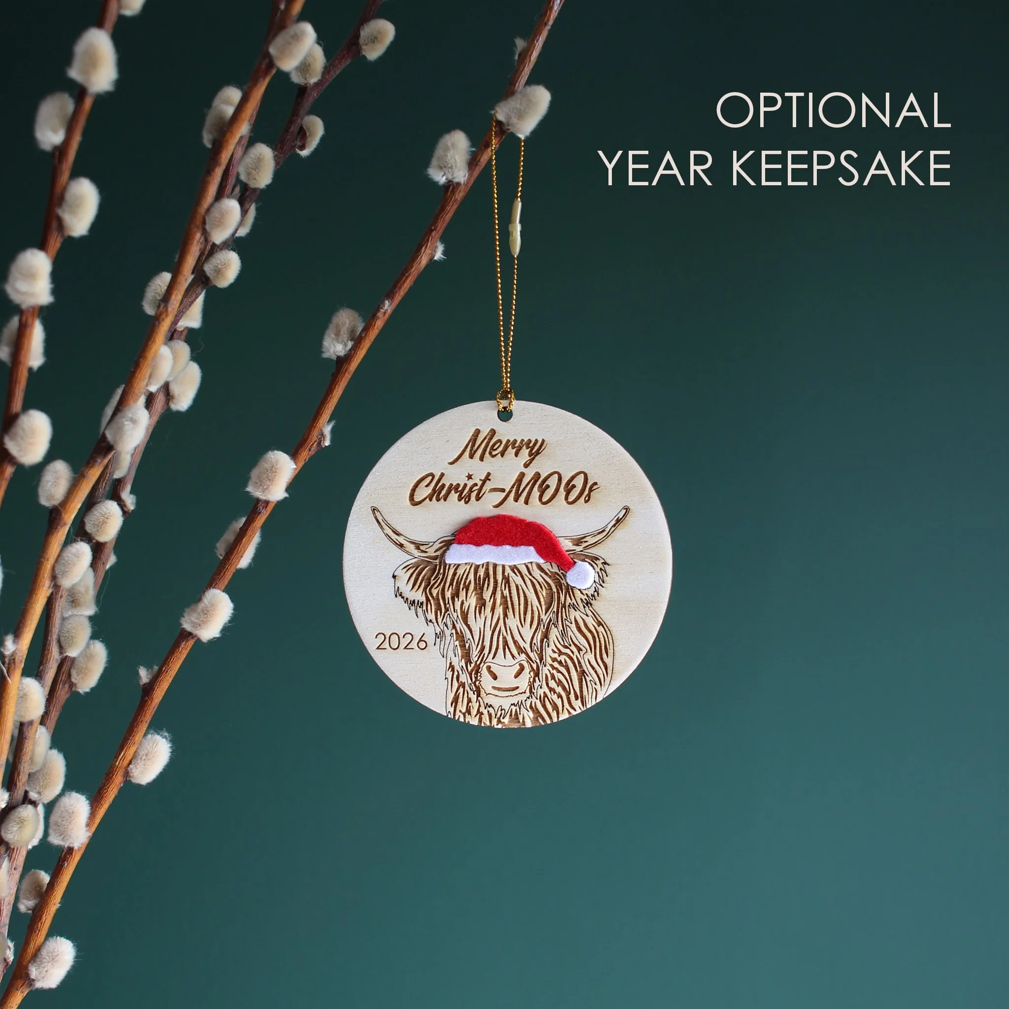 Wooden highland cow Christmas ornament with optional 2026 year engraving, featuring an original hand-drawn raccoon in a Santa hat and festive Christmas pun.