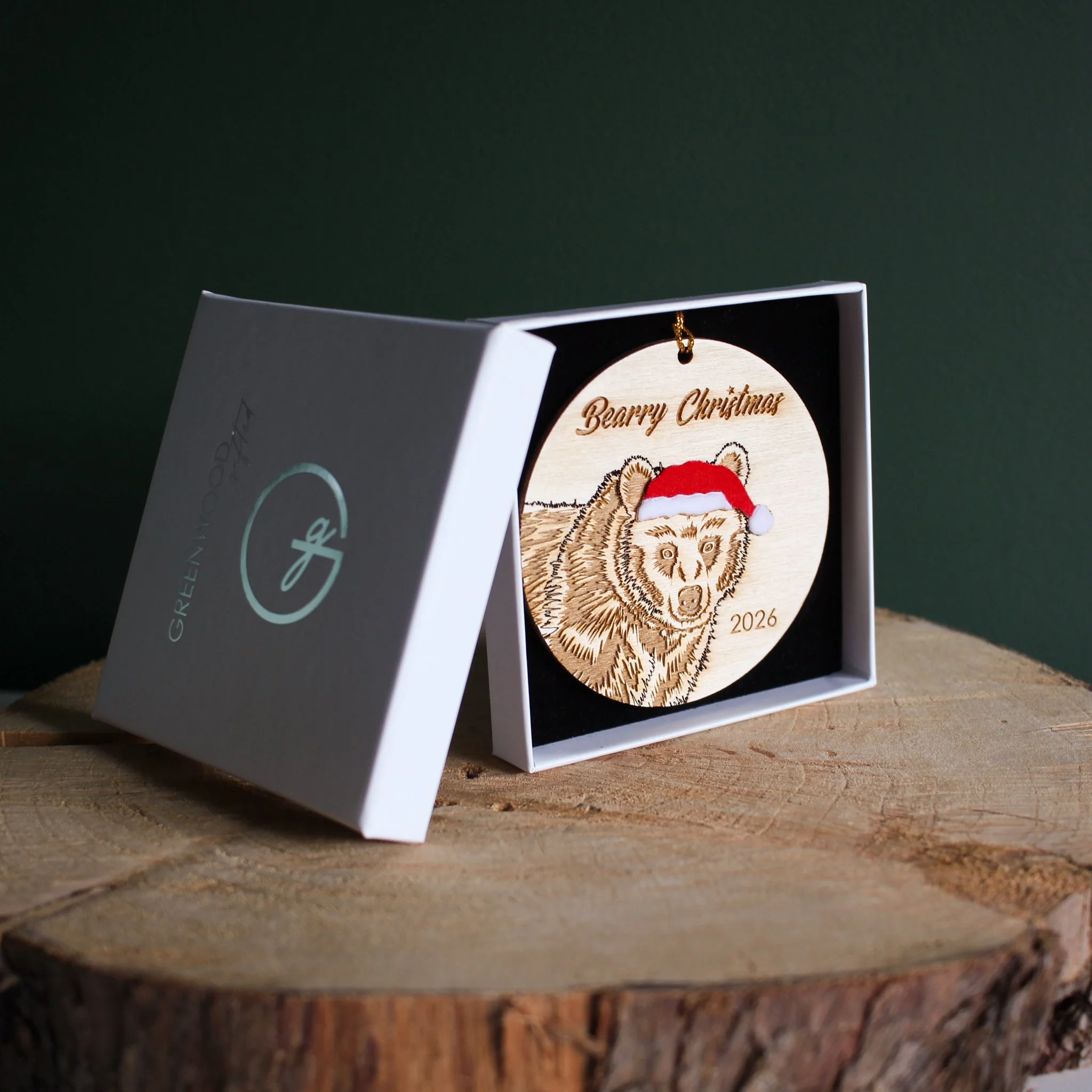 Wooden bear Christmas ornament with optional 2026 year engraving, presented in a white Greenwood Gifted gift box with black insert.