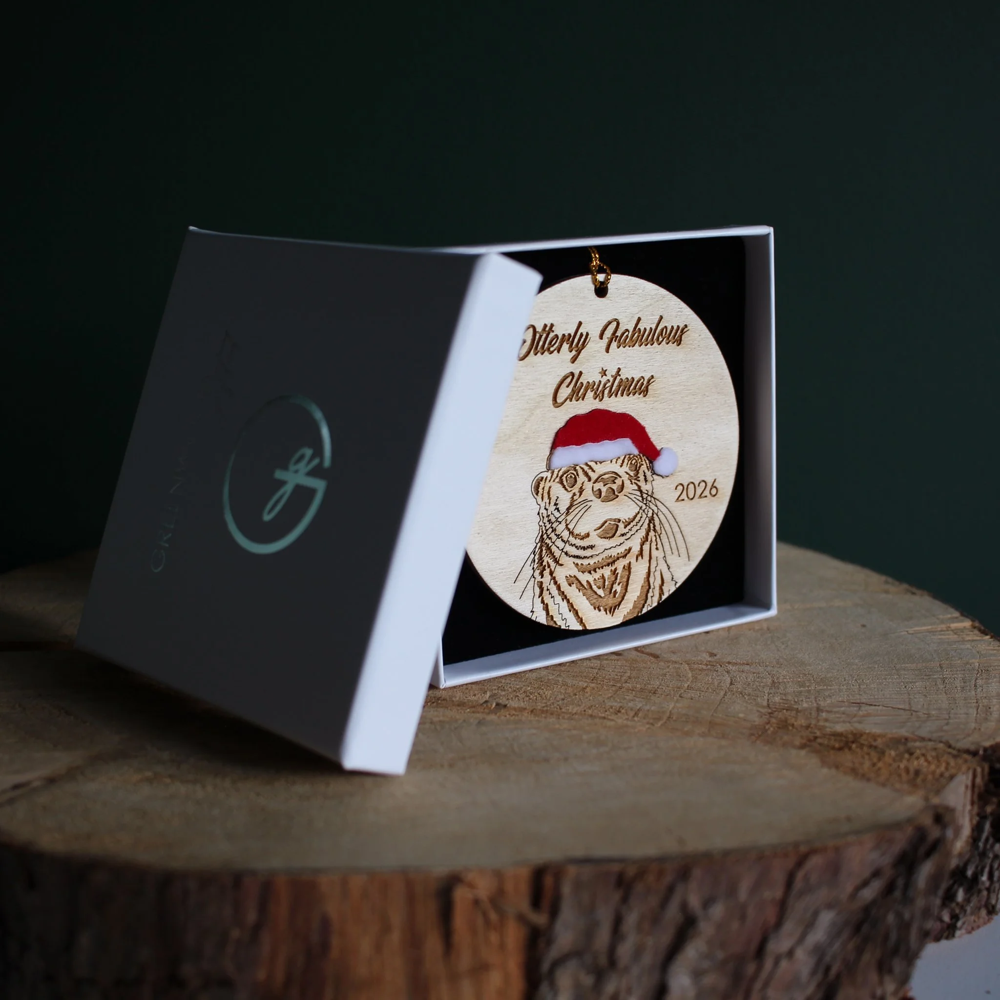 Wooden Otter Christmas ornament with optional 2026 year engraving, presented in a white Greenwood Gifted gift box with black insert.