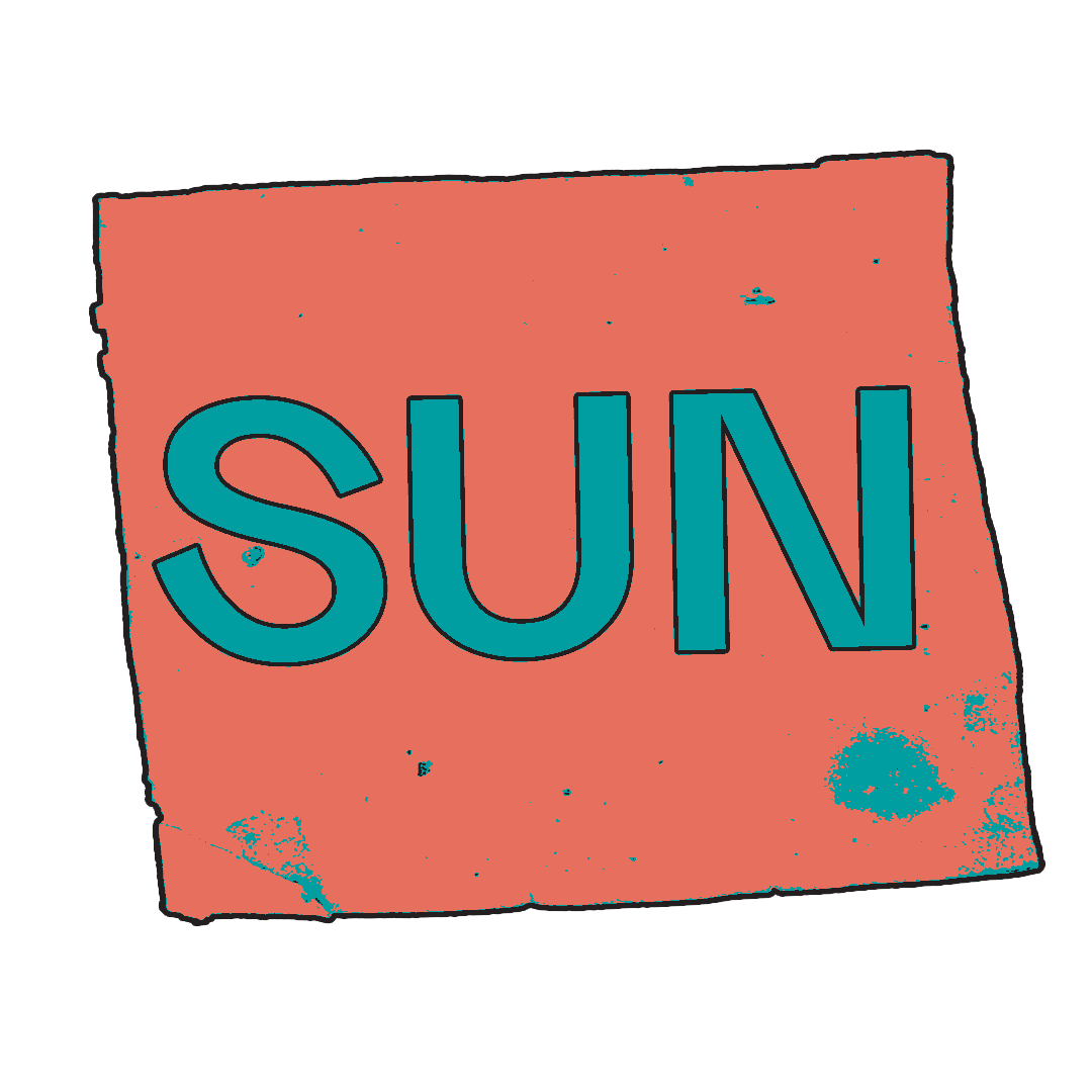 A stylized sign with the word 'SUN' in large blue letters on a distressed pink background.