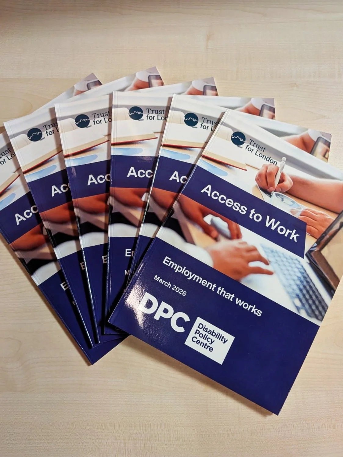 Several printed copies of the Disability Policy Centre’s Access to Work: Employment that Works report are displayed on a table, ready to be shared with attendees at the parliamentary event.