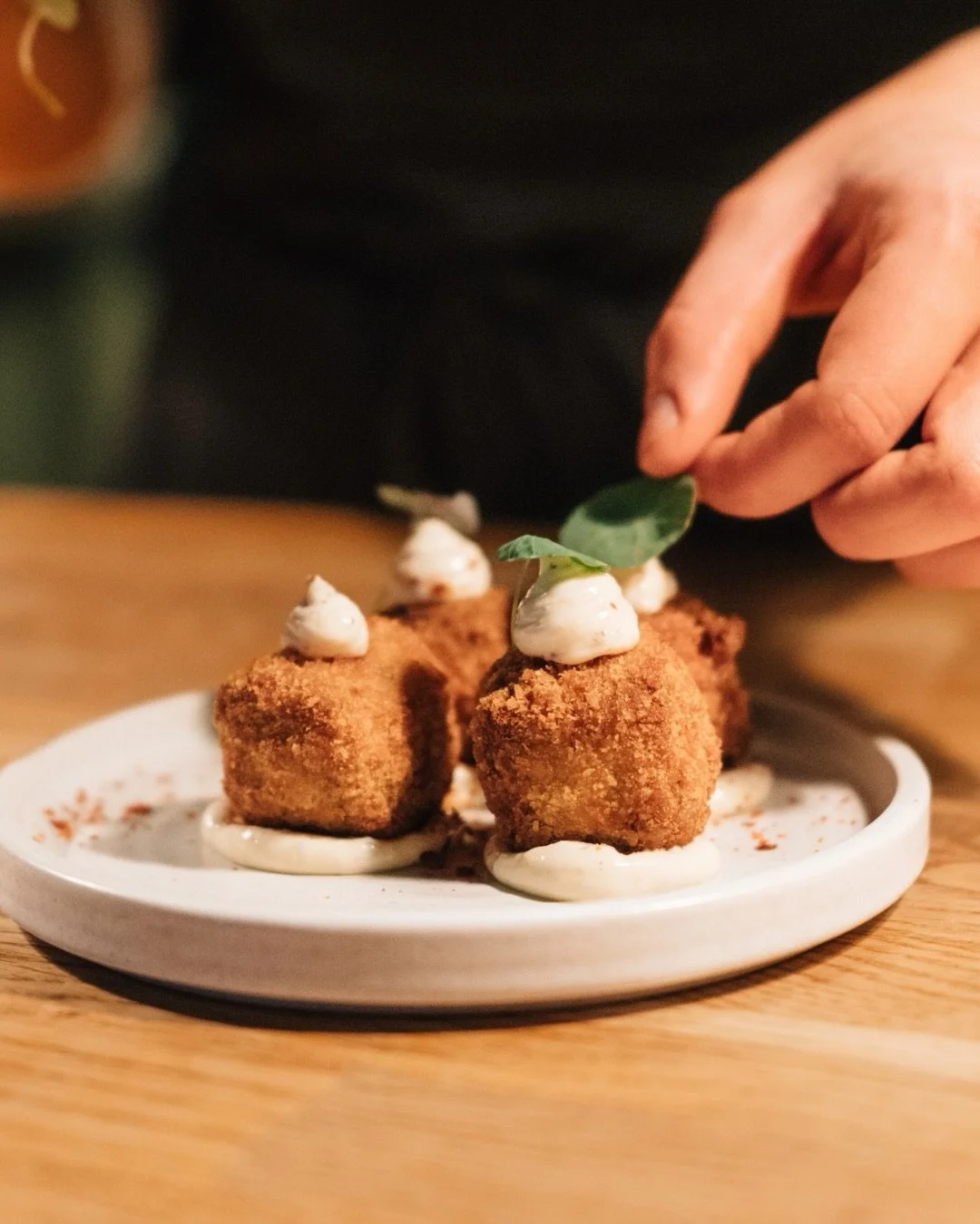 Some places earn their reputation quietly.

This is one of them, a wood-fired kitchen that lets the food do the talking. From brisket burgers to crispy croquettes fresh from the hearth, it&rsquo;s the kind of meal that has you planning your next visi