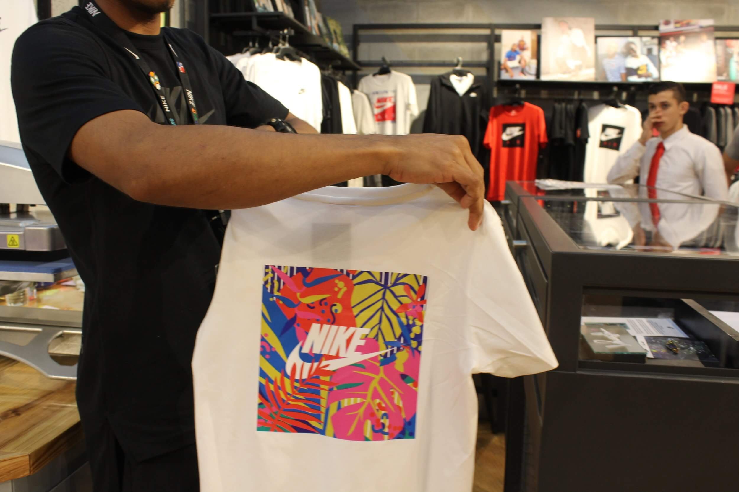 Back view of Nike collaboration T-shirt mockup with colorful tropical artwork by Mezclao Studio.