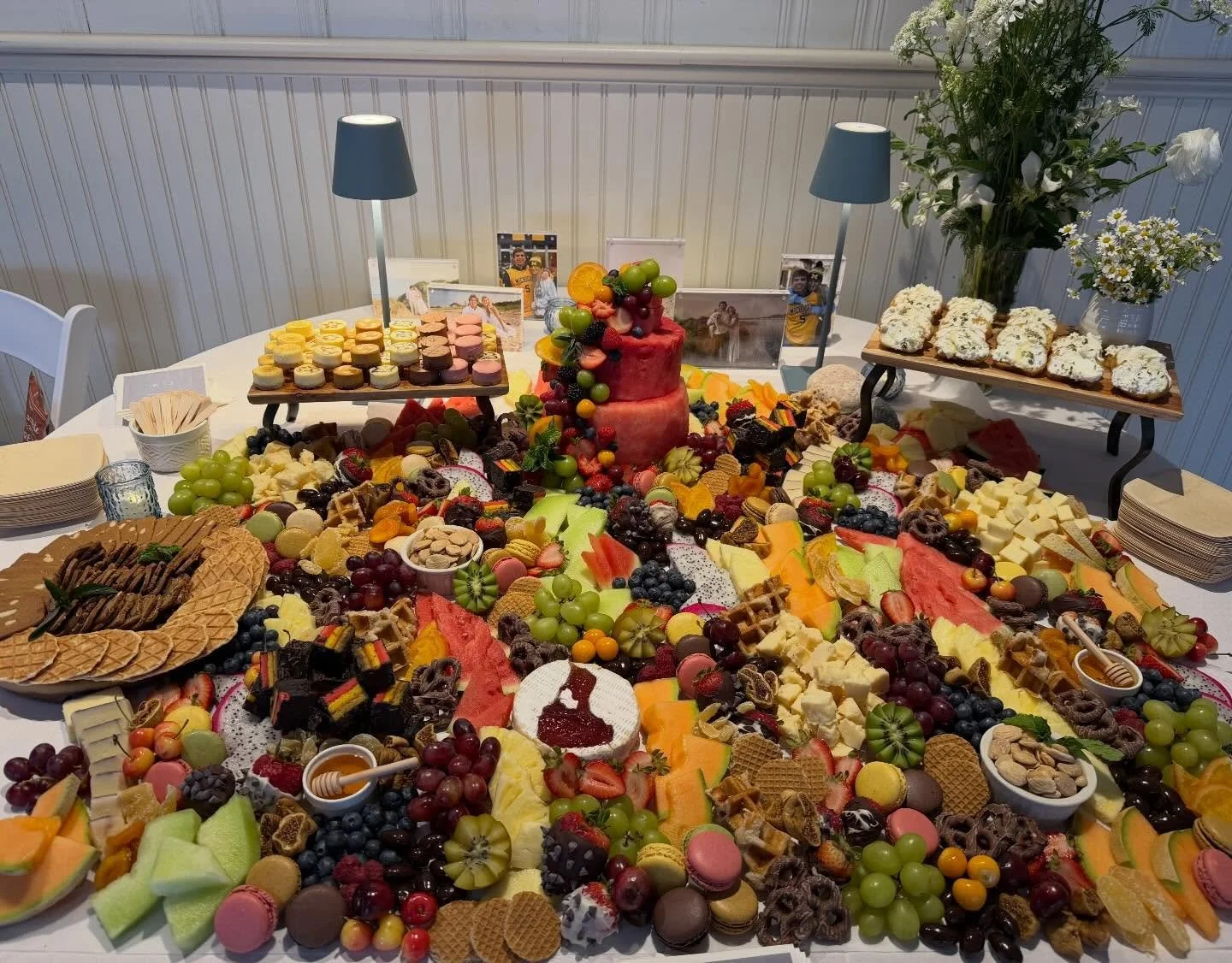 Beautiful dessert graze! Rainbow cookies, macaroons, mini cheesecakes, watermelon cake, Espresso bellivitano cheese, @richeeses ricotta crostini and stunning flowers from @__shadestudio. #wedding #blockisland #charcuterie #grazingtable #cheese