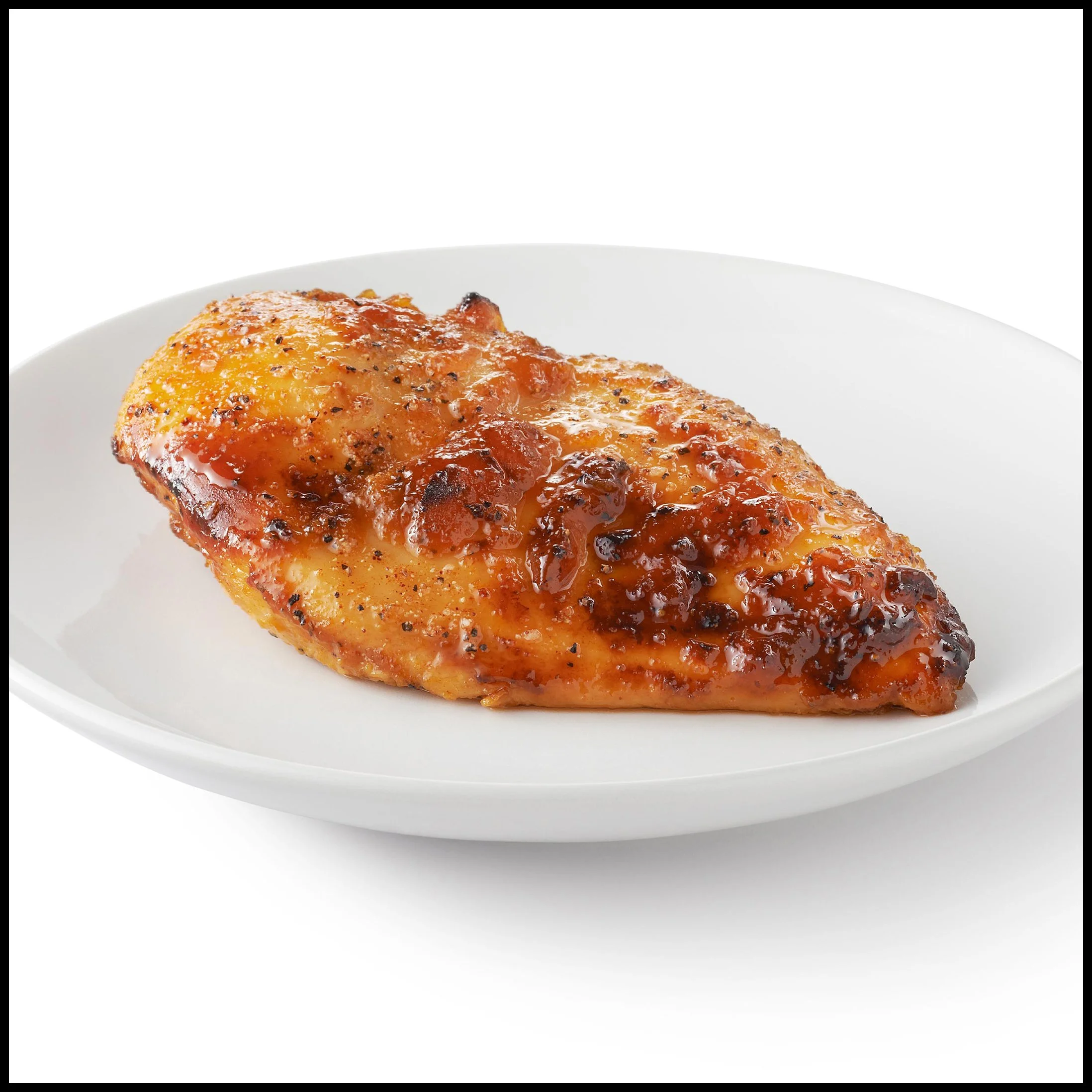 Baked chicken thigh with barbecue sauce on a white plate