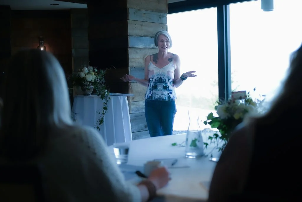 Emma Hull speaking to a group of women about confidence, reinvention, and personal growth