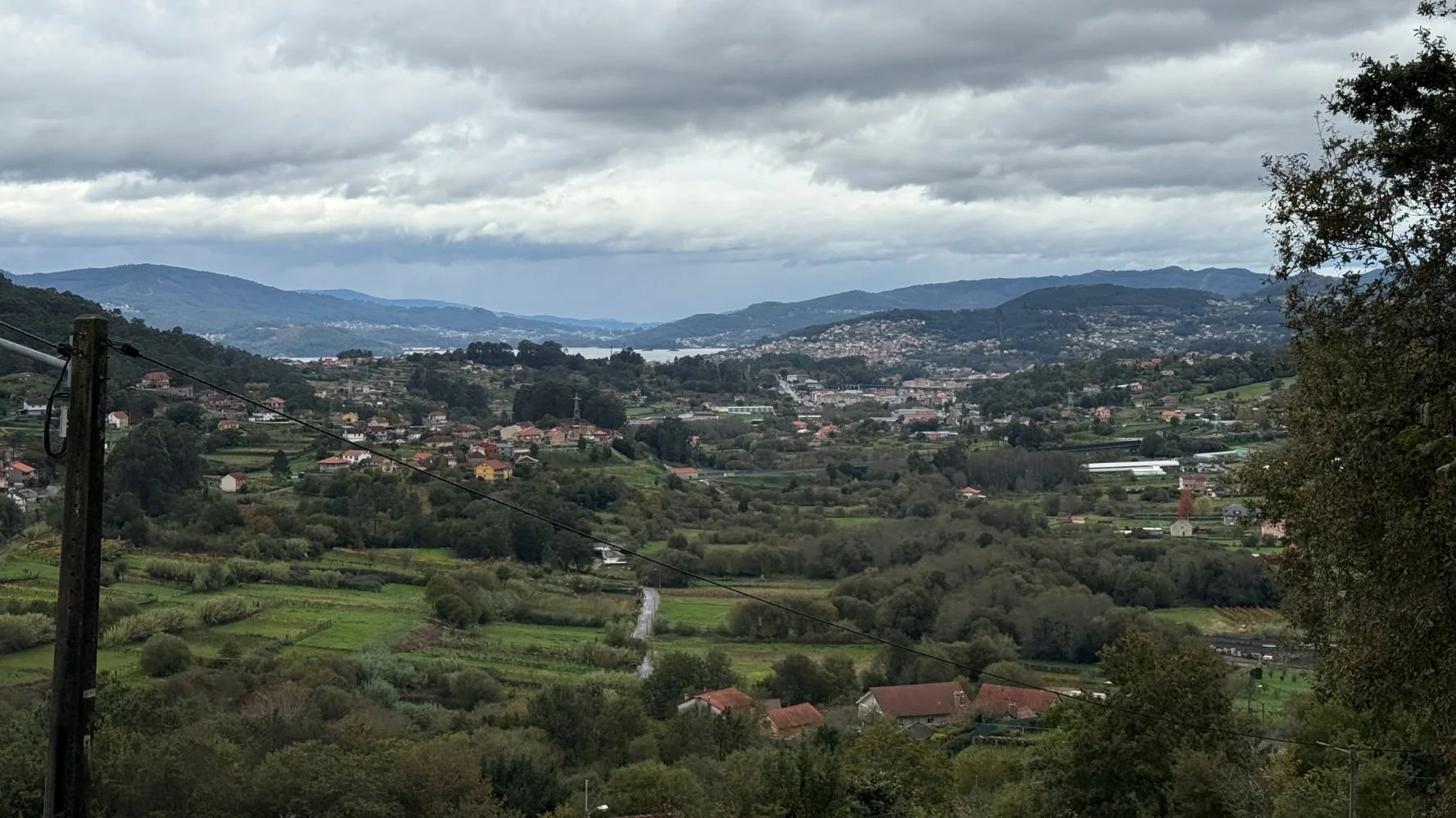 View over rolling hills and small villages along the Camino de Santiago, showing the scale of the landscape pilgrims walk through