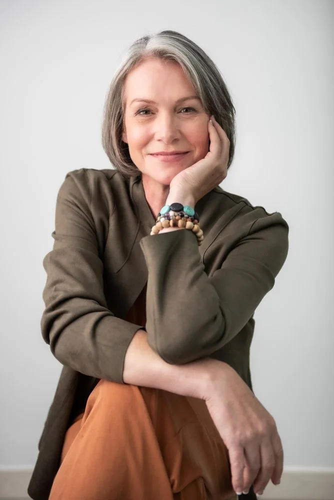 Emma Hull, certified life coach in Kamloops BC, seated in studio portrait