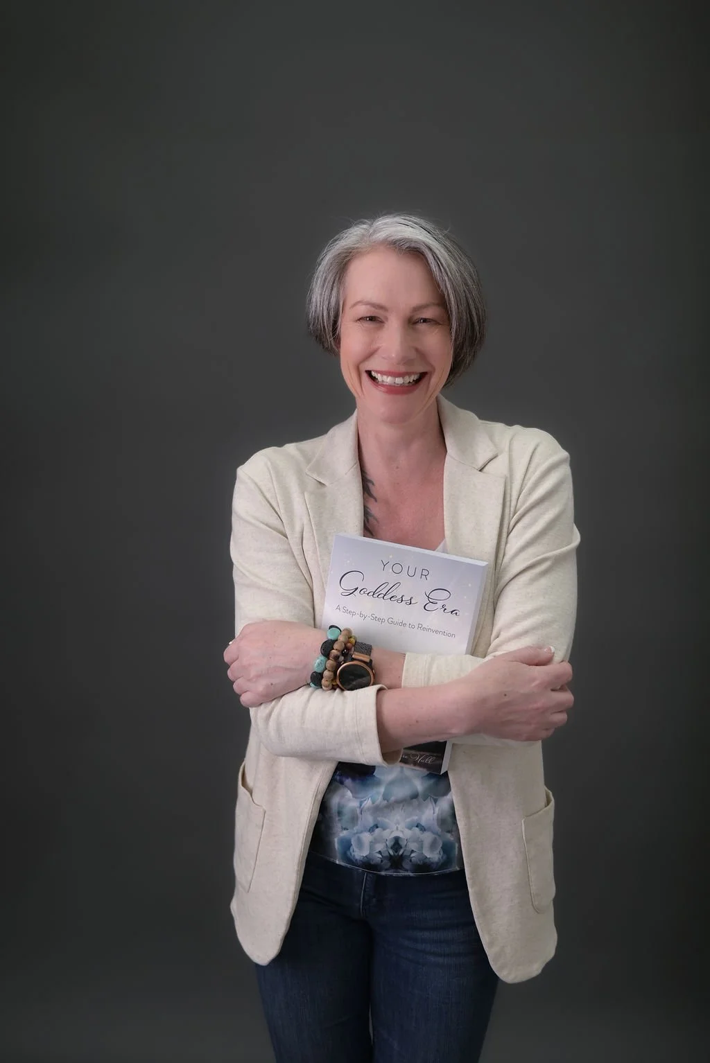 Emma Hull holding her best-selling self-help book Your Goddess Era: A Step-by-Step Guide to Reinvention