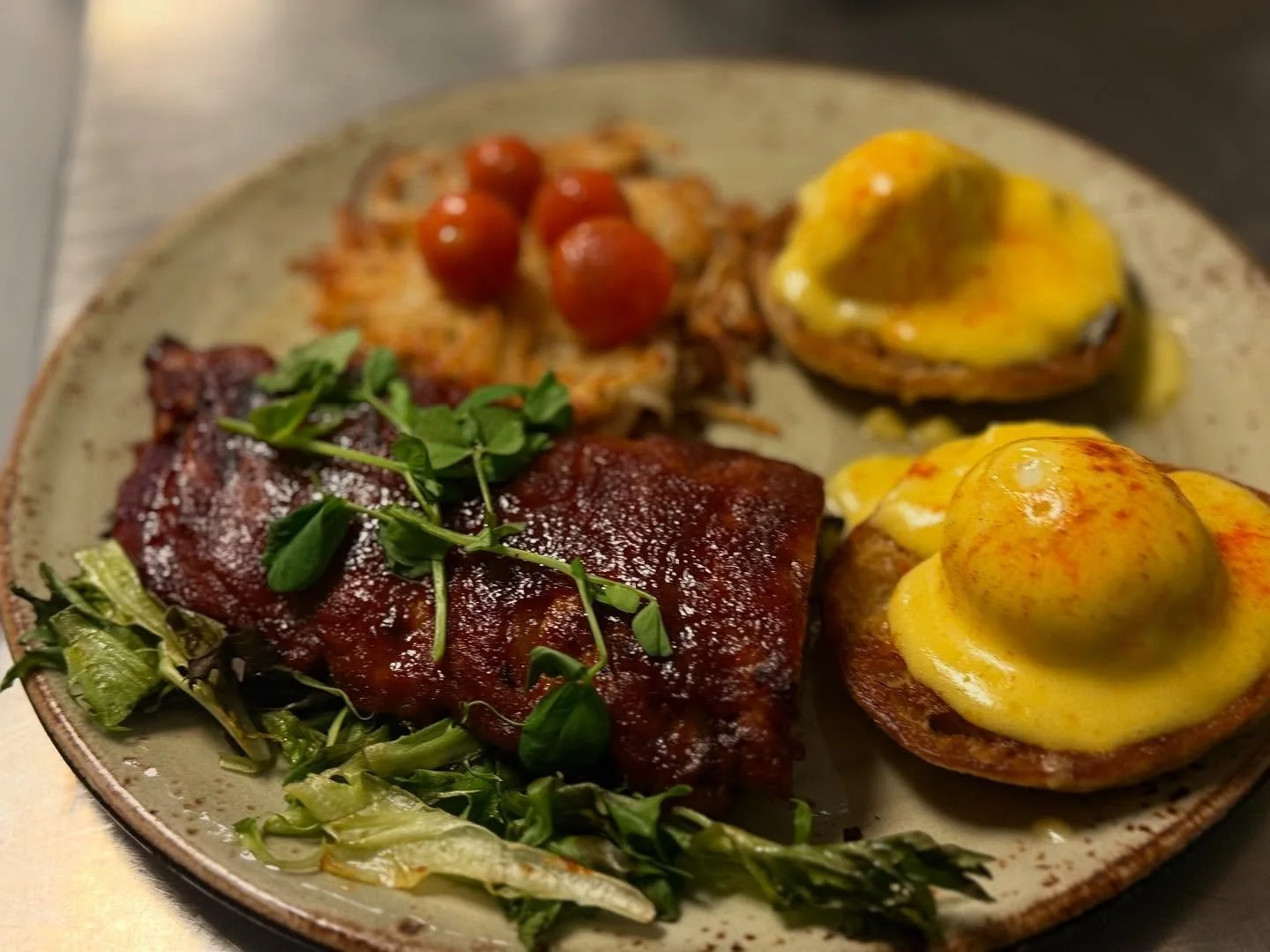Champ special , grilled baby back ribs aside of classic soft poached benny and hash browns