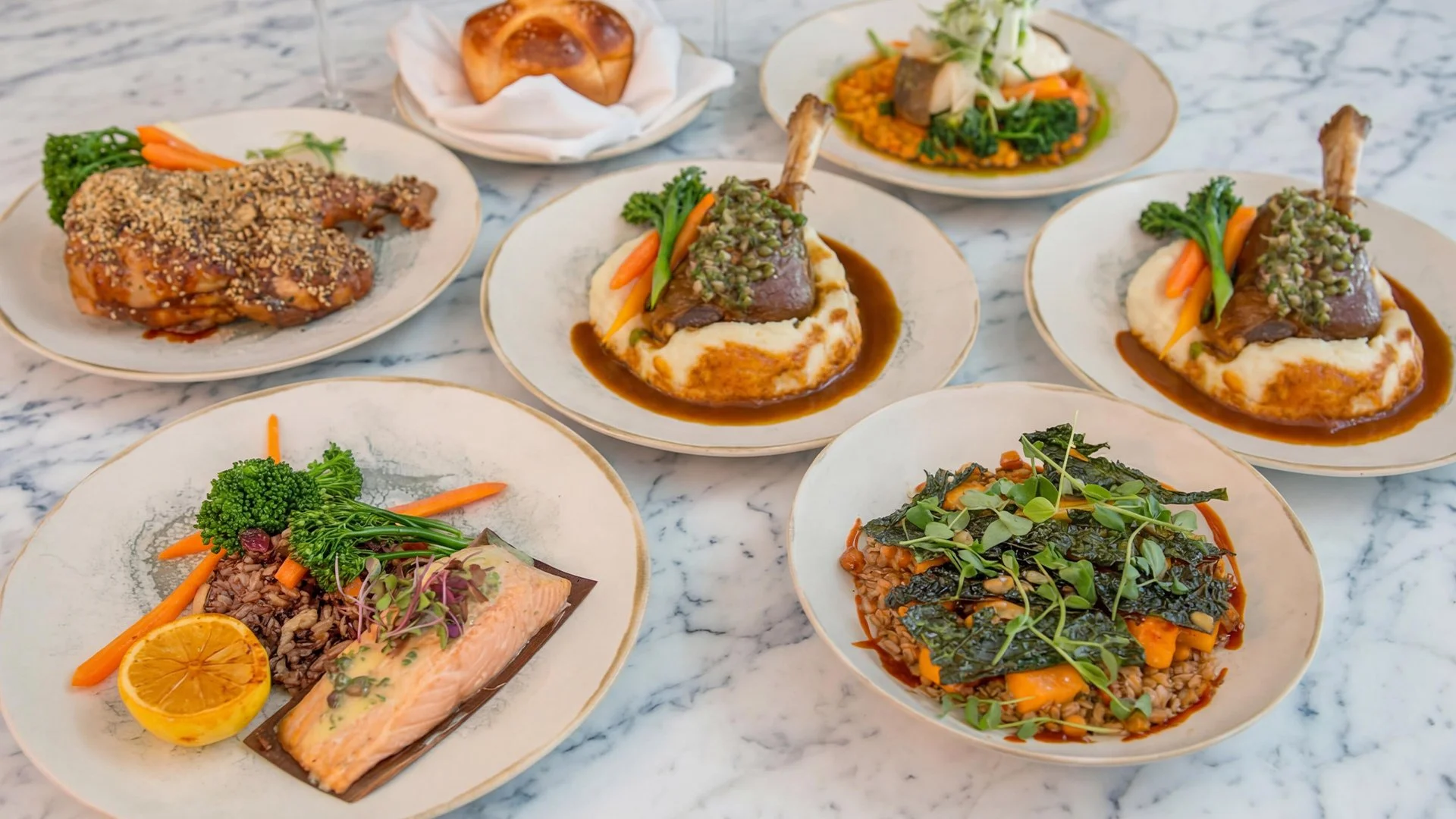Assorted plates of gourmet dishes.