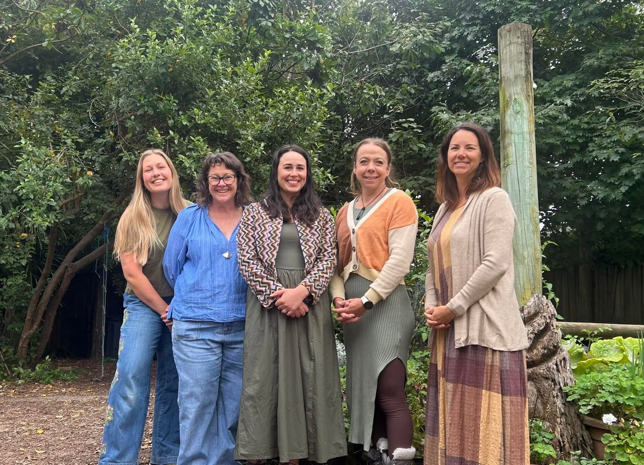 Kaiako at Four Seasons Kindergarten standing in the garden. Left to right: Tamara, Traceylee, Moni, Fenella and Natasja