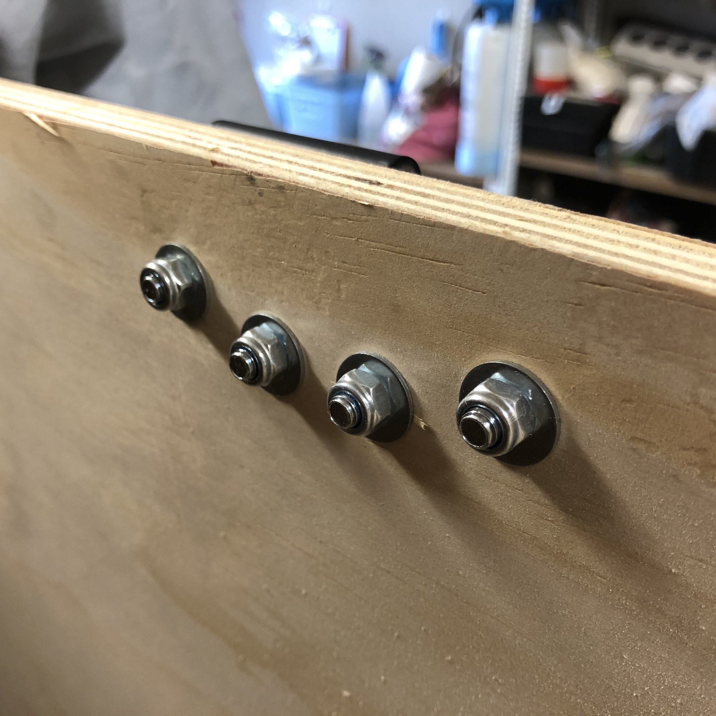 Use washers between the ply and the nut