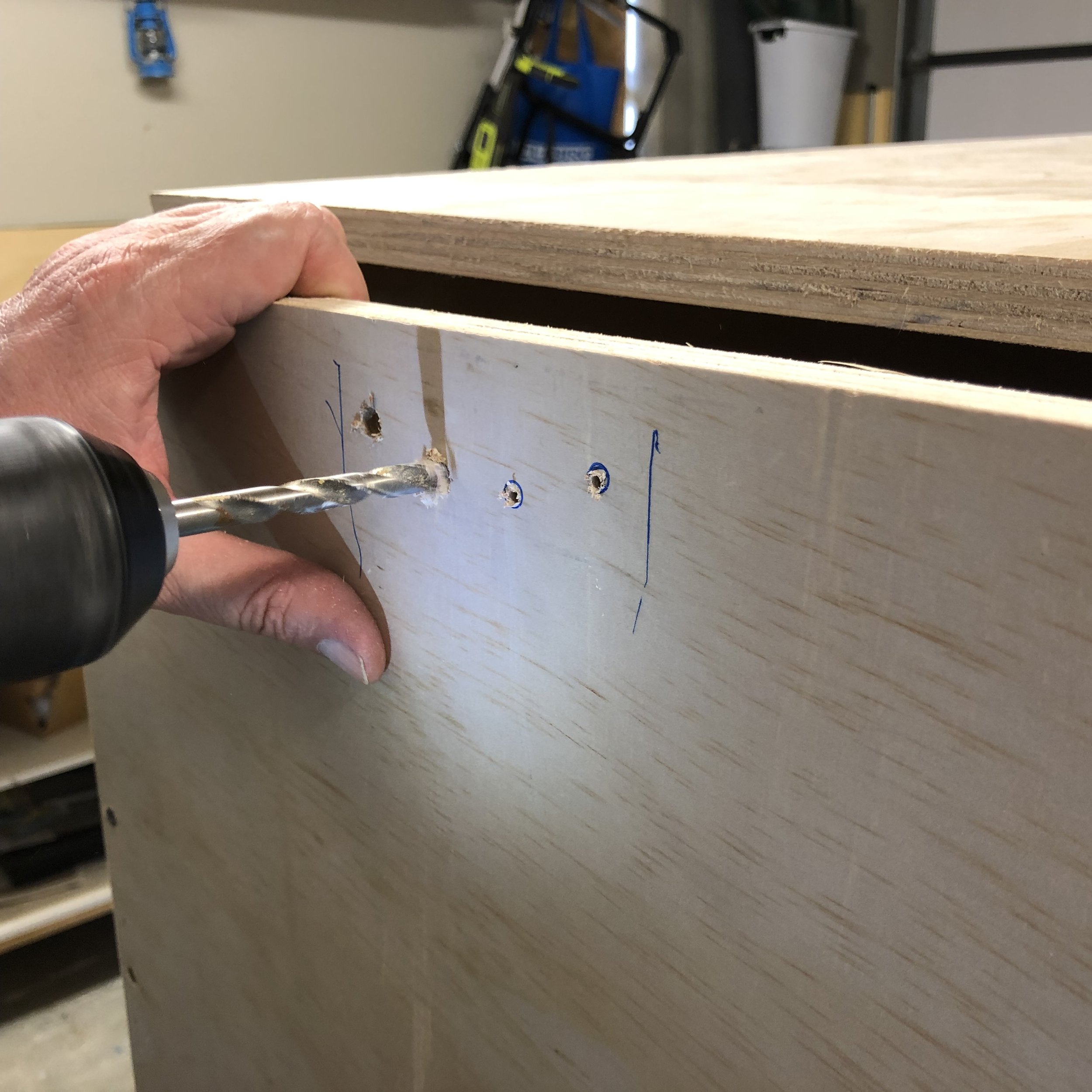 Use pilot holes to guide drill for the larger holes