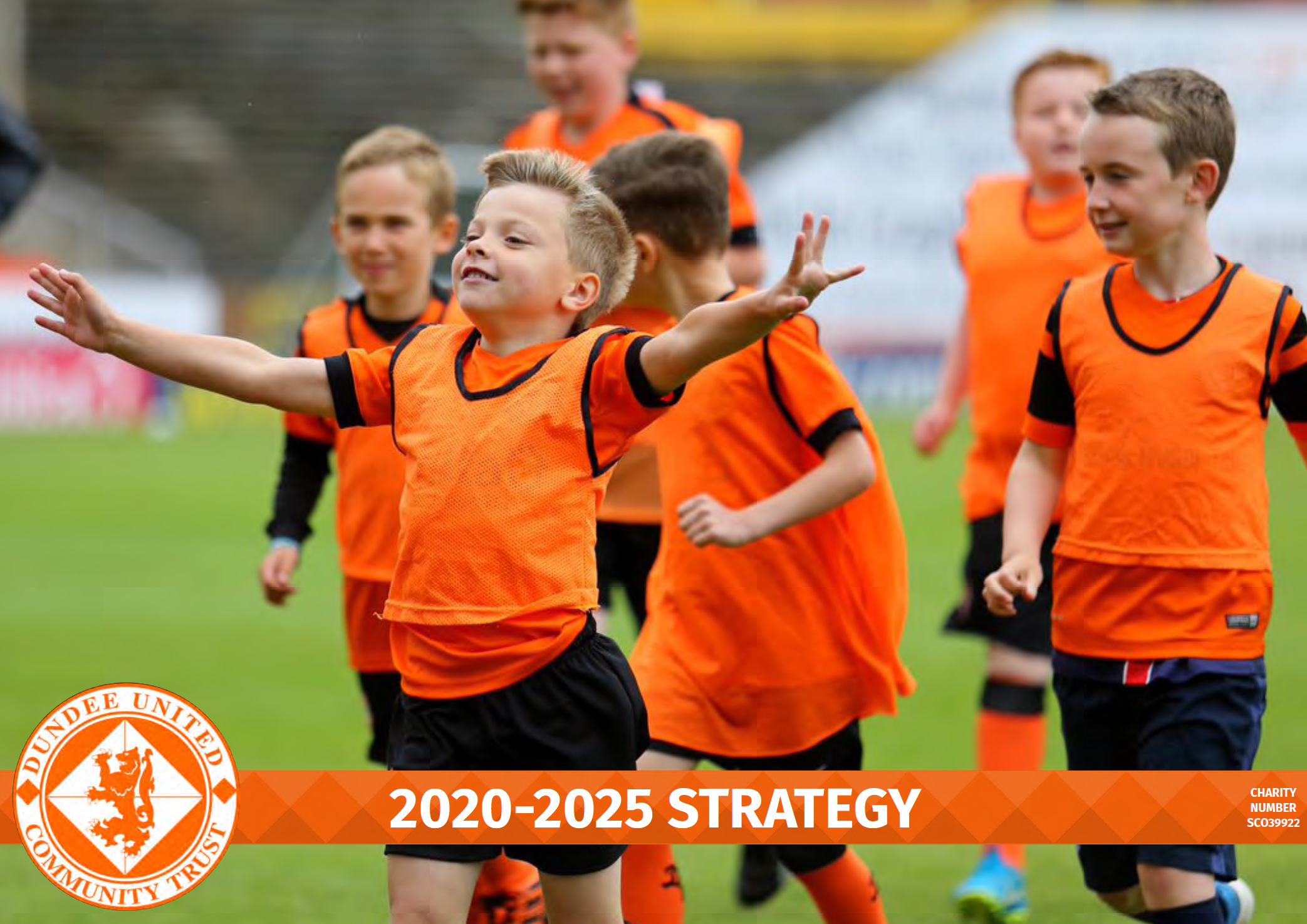 Group of young children in orange soccer jerseys playing on a field, part of the Dundee United Community Trust 2020-2025 strategy document.