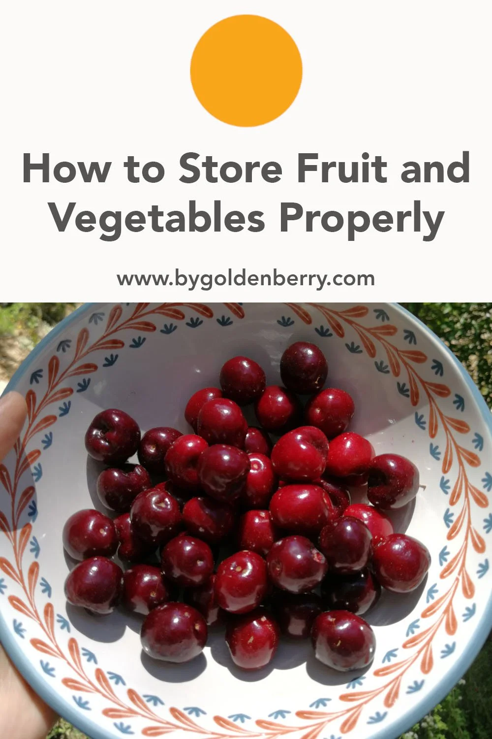 A photo of a bowl of dark red cherries. The bowl is white with blue and red trimmings around the edge. Above the photo there is orange text which reads "How to Make Fruit and Veg Last Longer". It is an image for saving to pinterest.