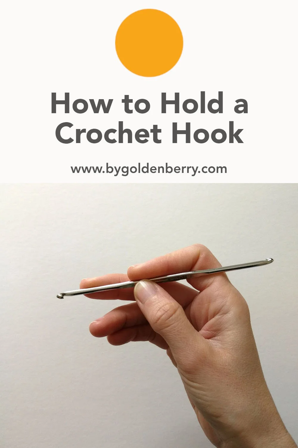 A white, right hand is holding a silver crochet hook. The thumb and forefinger are holding top and bottom in the same place and the middle finger is more towards the front hook. Above, dark grey text on white reads "How to Hold a Crochet Hook"