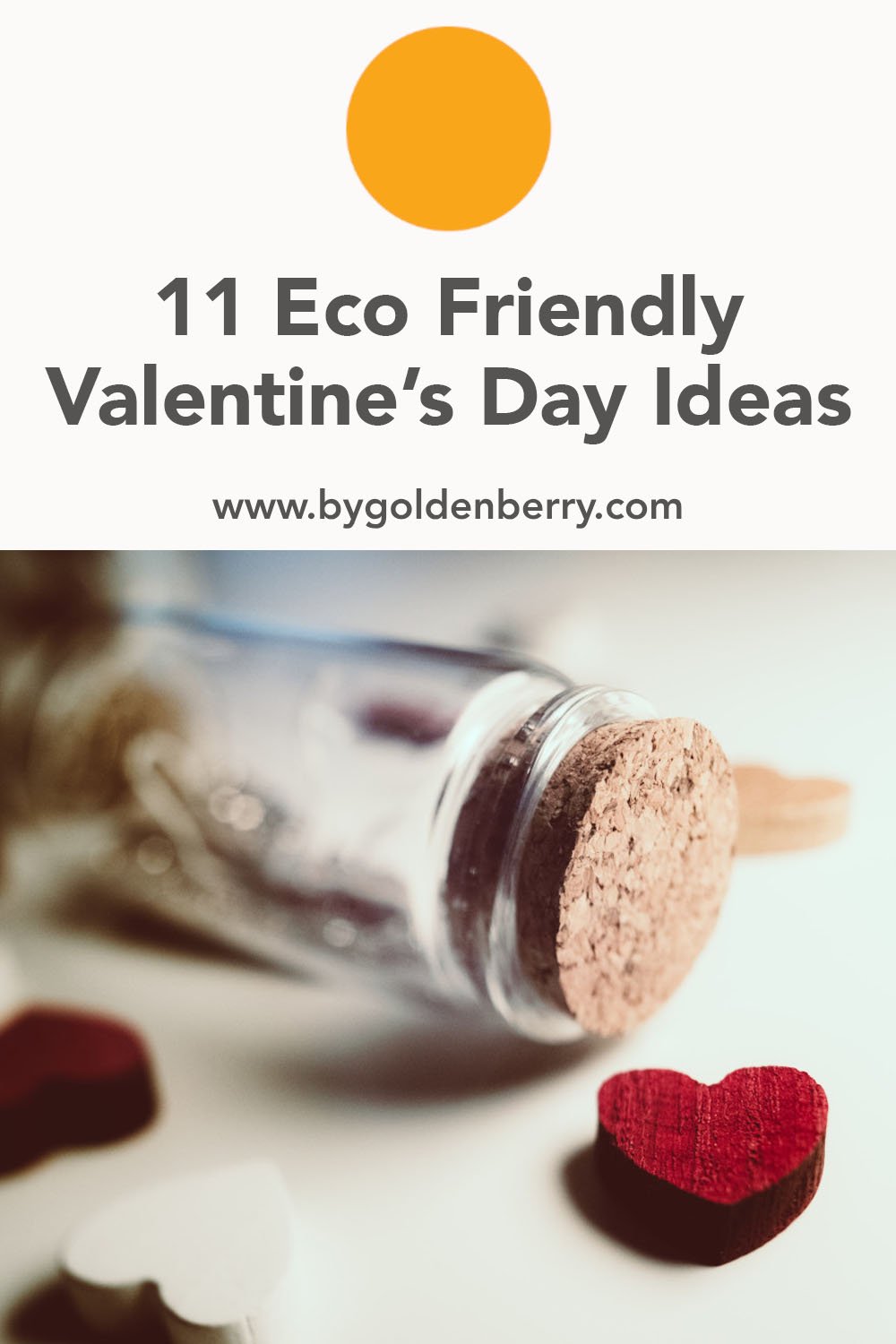 A close up photo of a clear glass tube with a cork stopper laying on its side on a white surface. In front there is a small, red, wooden heart  with others in the background. Above is dark grey text which reads "11 Eco Friendly Valentine's Day Ideas"