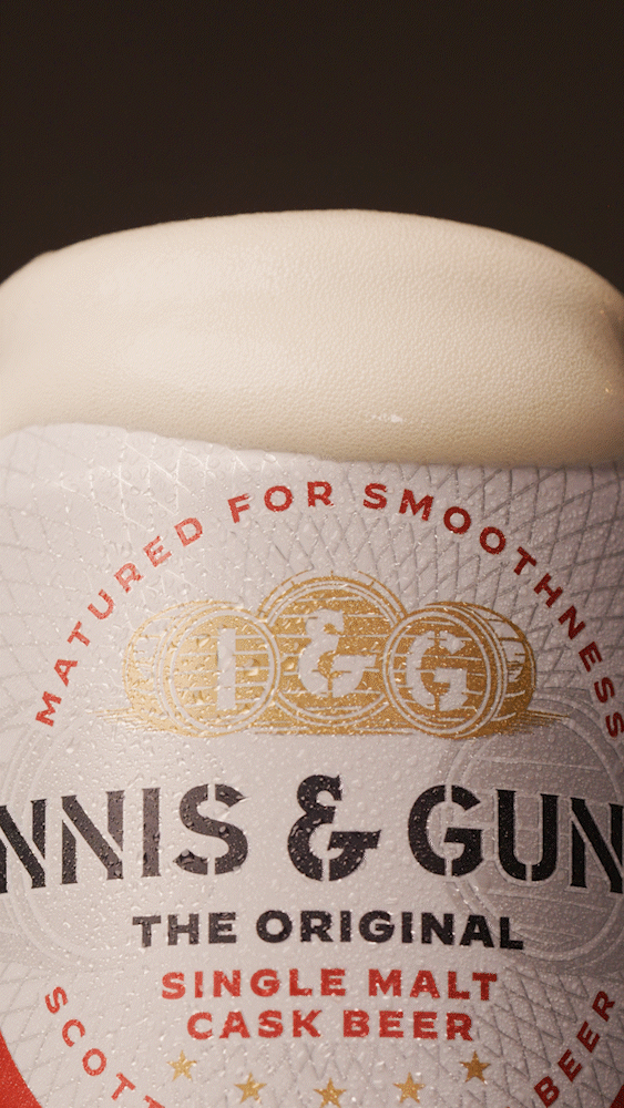 Close-up of a beer bottle label with the text "Innis & Gunn: The Original Single Malt Cask Beer" and gold coins with the letters 'DGC' on them.