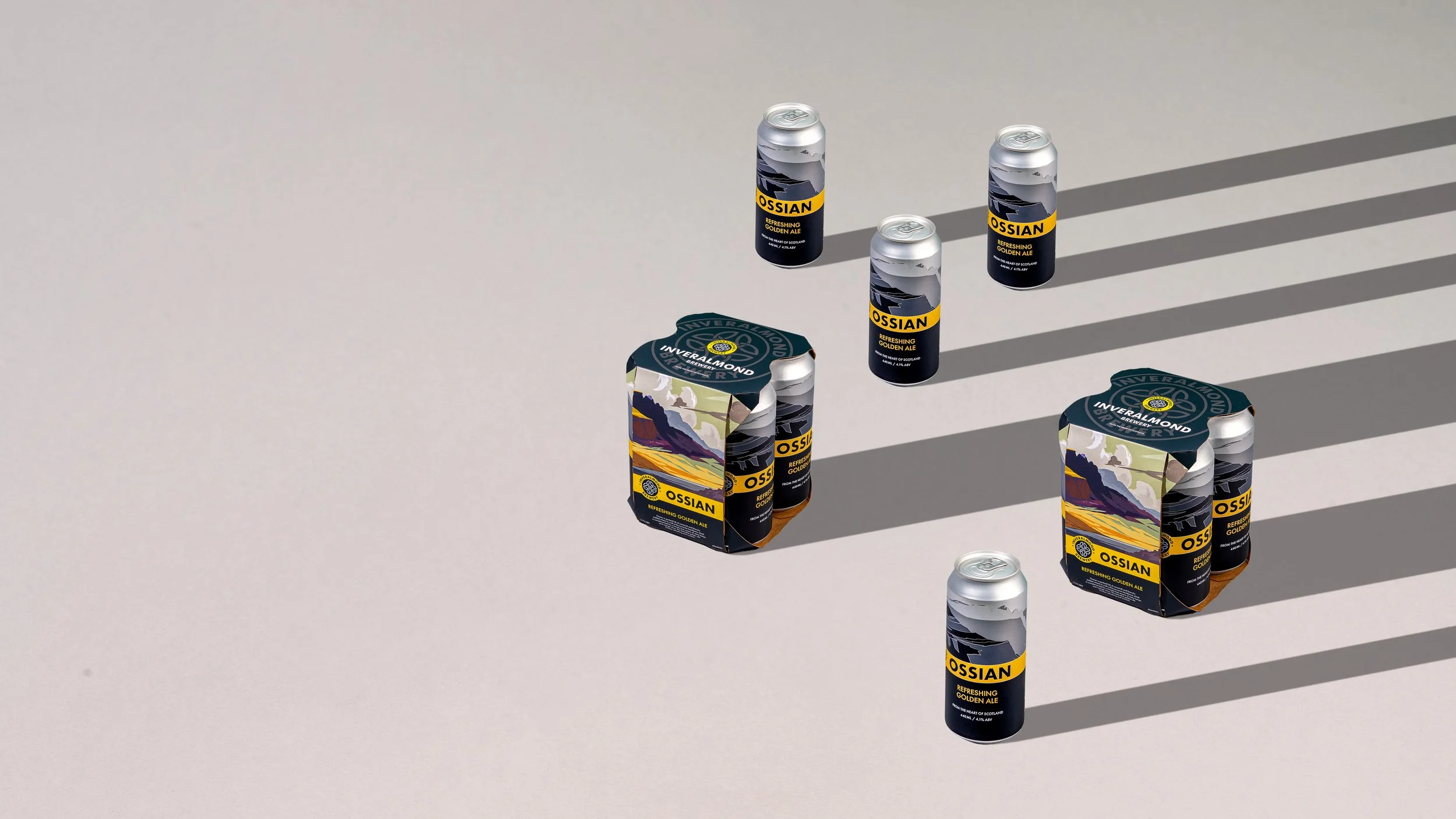 Four cans of Ossian refreshing golden ale and two six-pack cartons of Inveralmond beer on a light screen background, with shadows cast by sunlight.