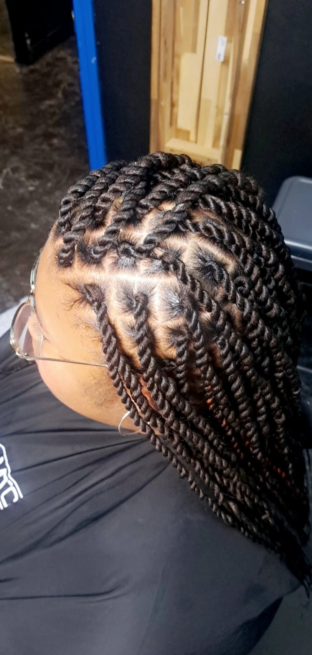 Close-up of a person with freshly done twisted braids hairstyle.