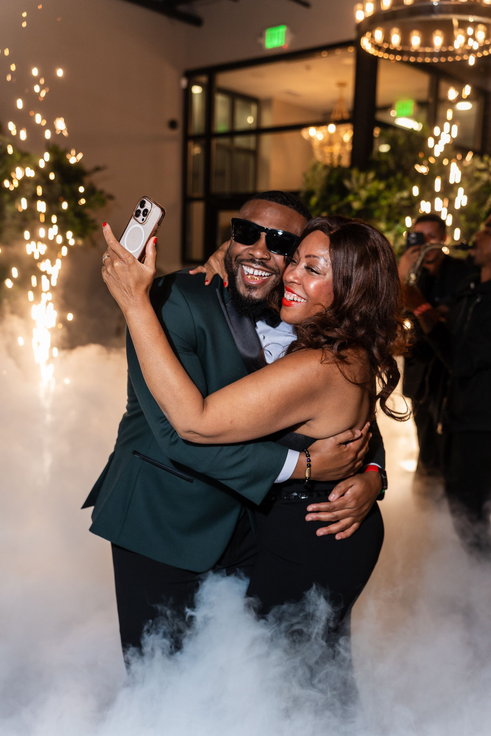 Couple laughing together as sparklers light the room at a Maryland event
