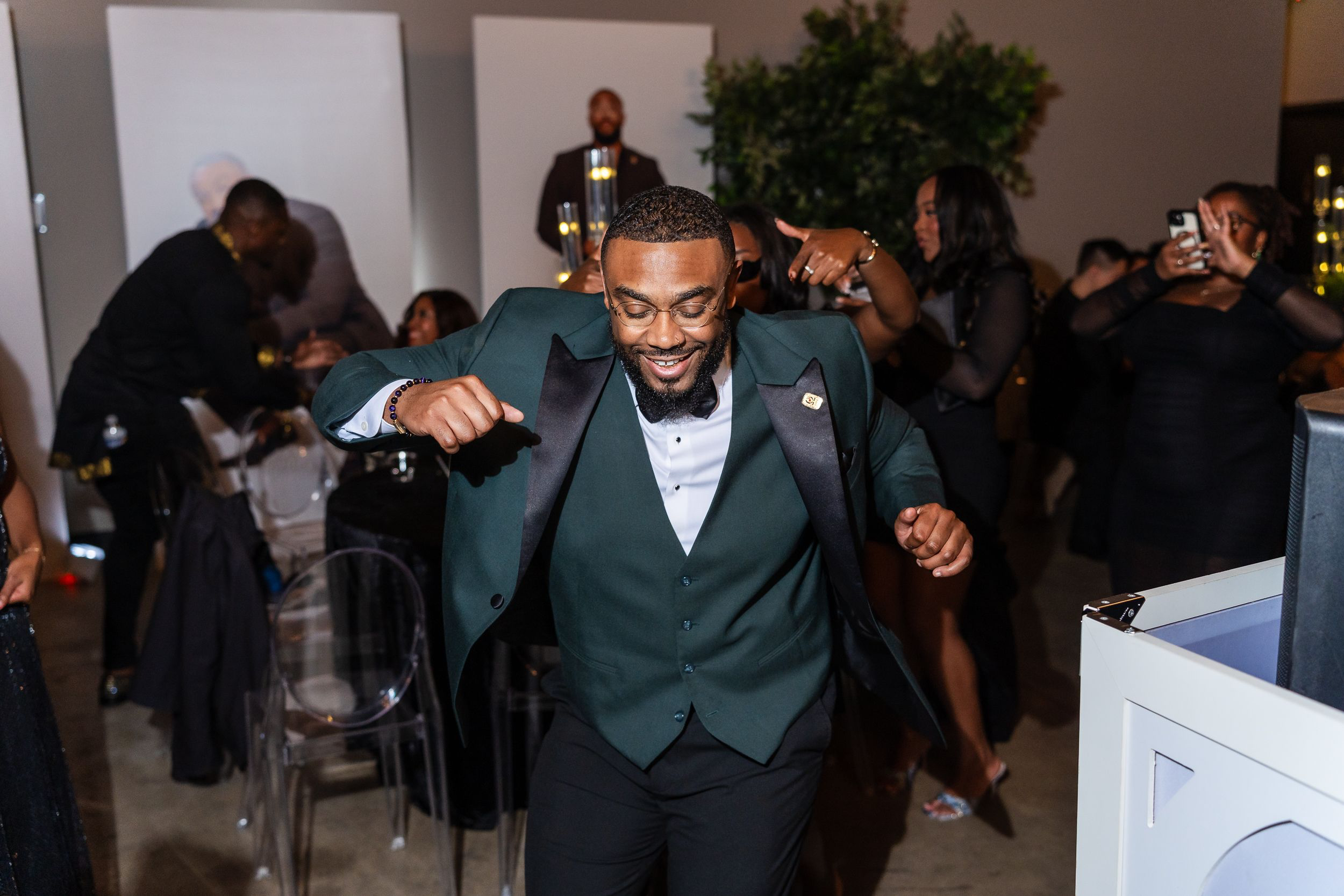 Two guests dancing in emerald tuxedos at a Baltimore birthday party