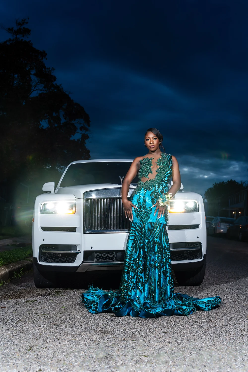 Prom sendoff beside a Rolls-Royce in a teal gown