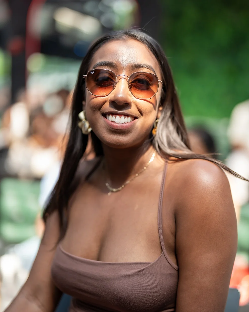 Guest with braids smiling at an all-white day party