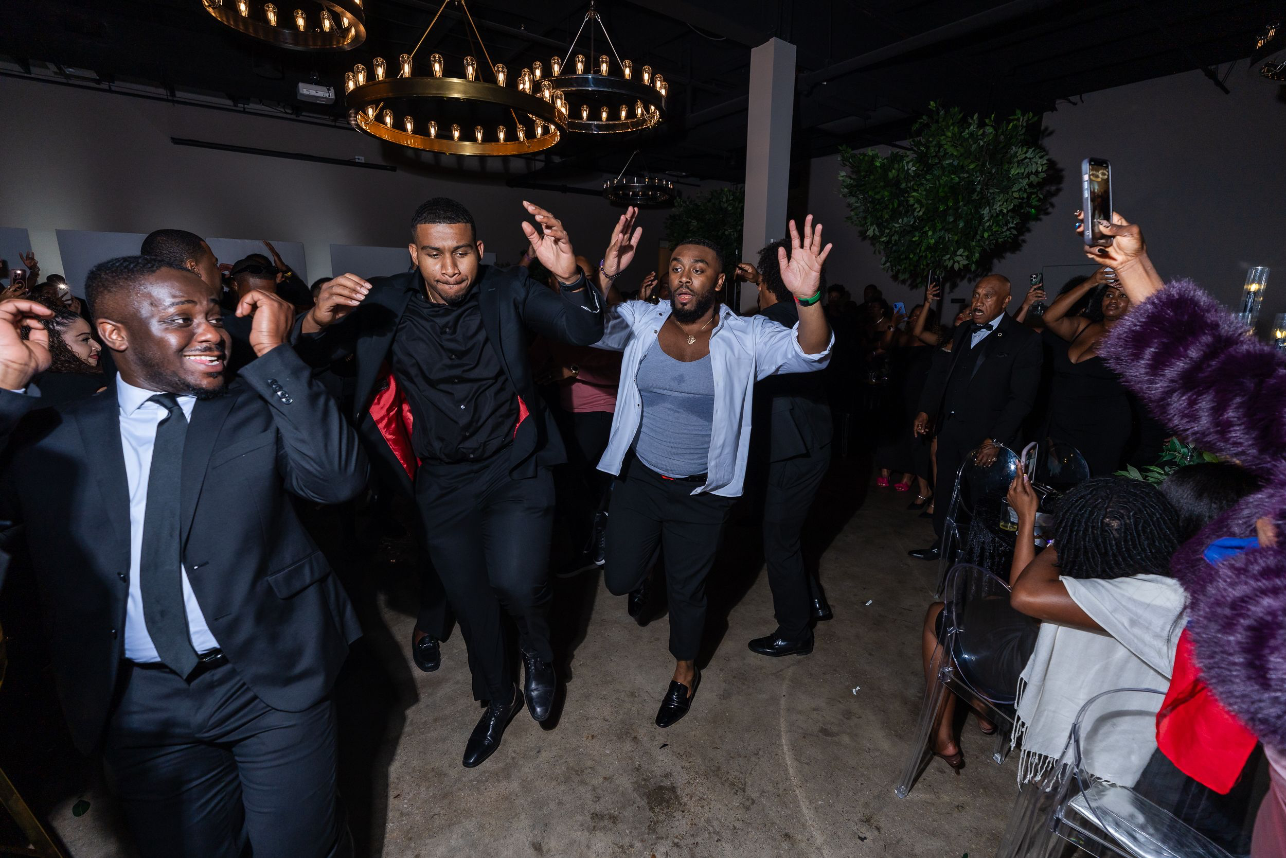 Crowded dance floor at a black-and-gold birthday party in Baltimore