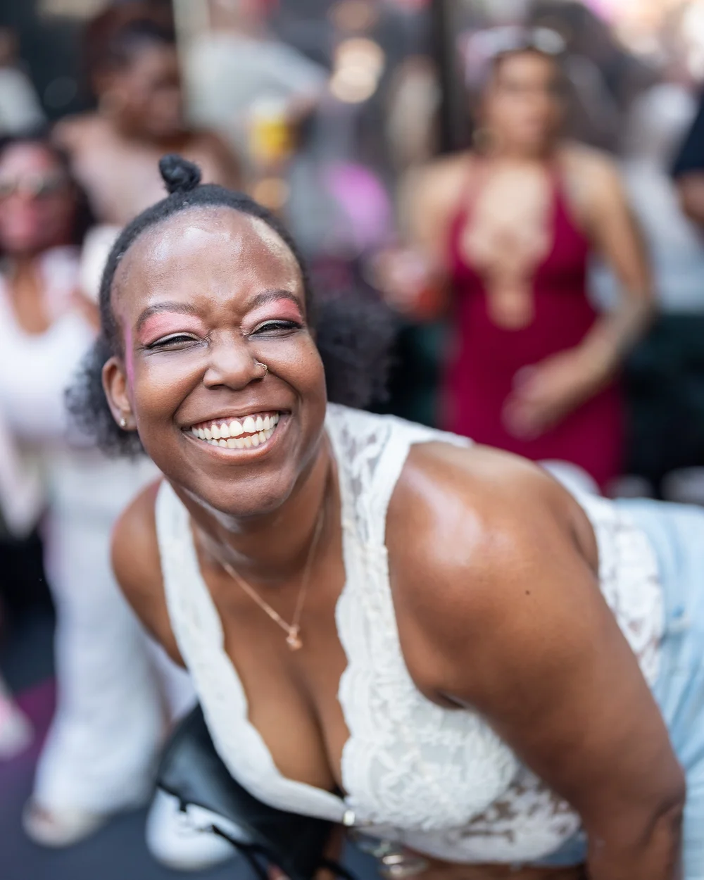 Guest laughing mid-conversation at a Baltimore day party