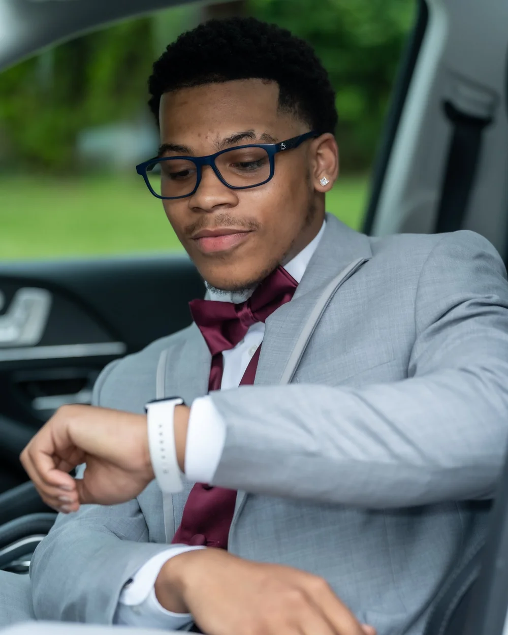 Prom portrait of a young man in grey with a red tie