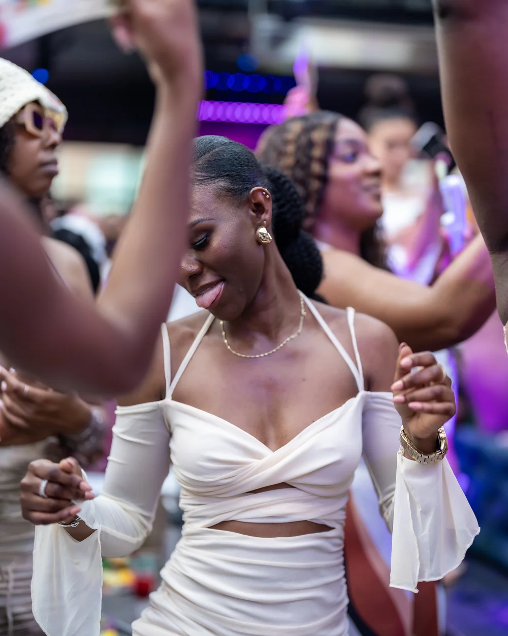 Guest dancing with both hands up at a Baltimore day party