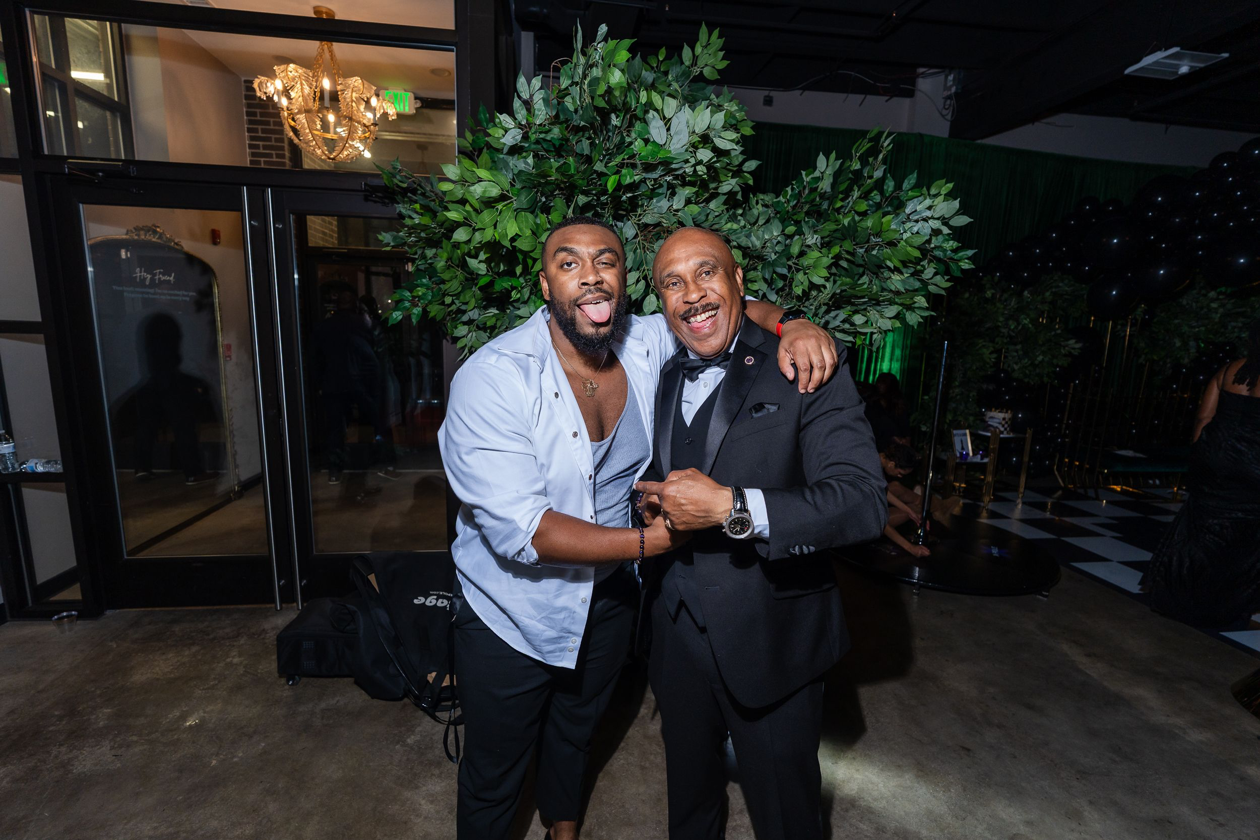 Two guests laughing together at the end of the night