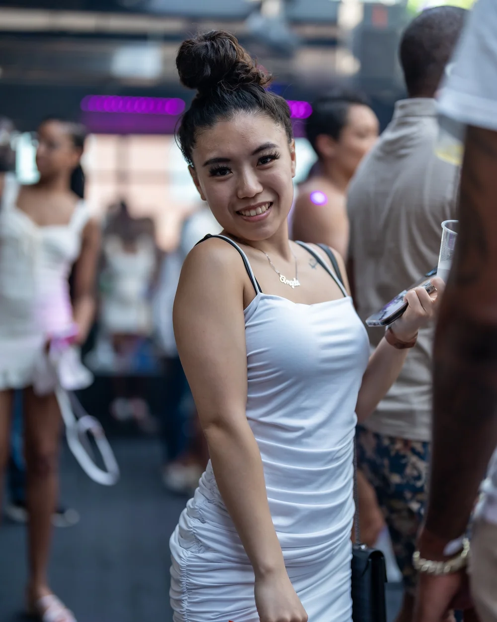 Guest in a white tank top with the party behind her