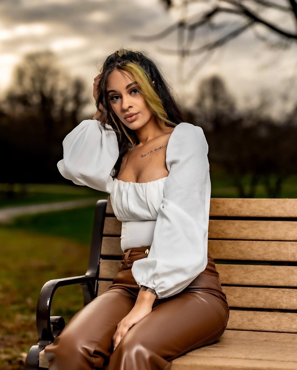 Outdoor bench portrait in a white shirt