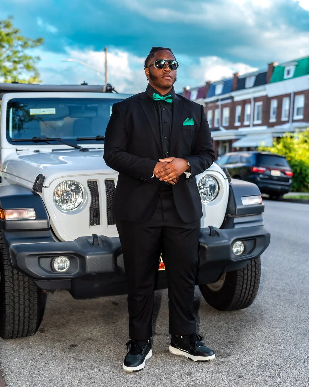 Prom sendoff portrait of a young man in a black suit