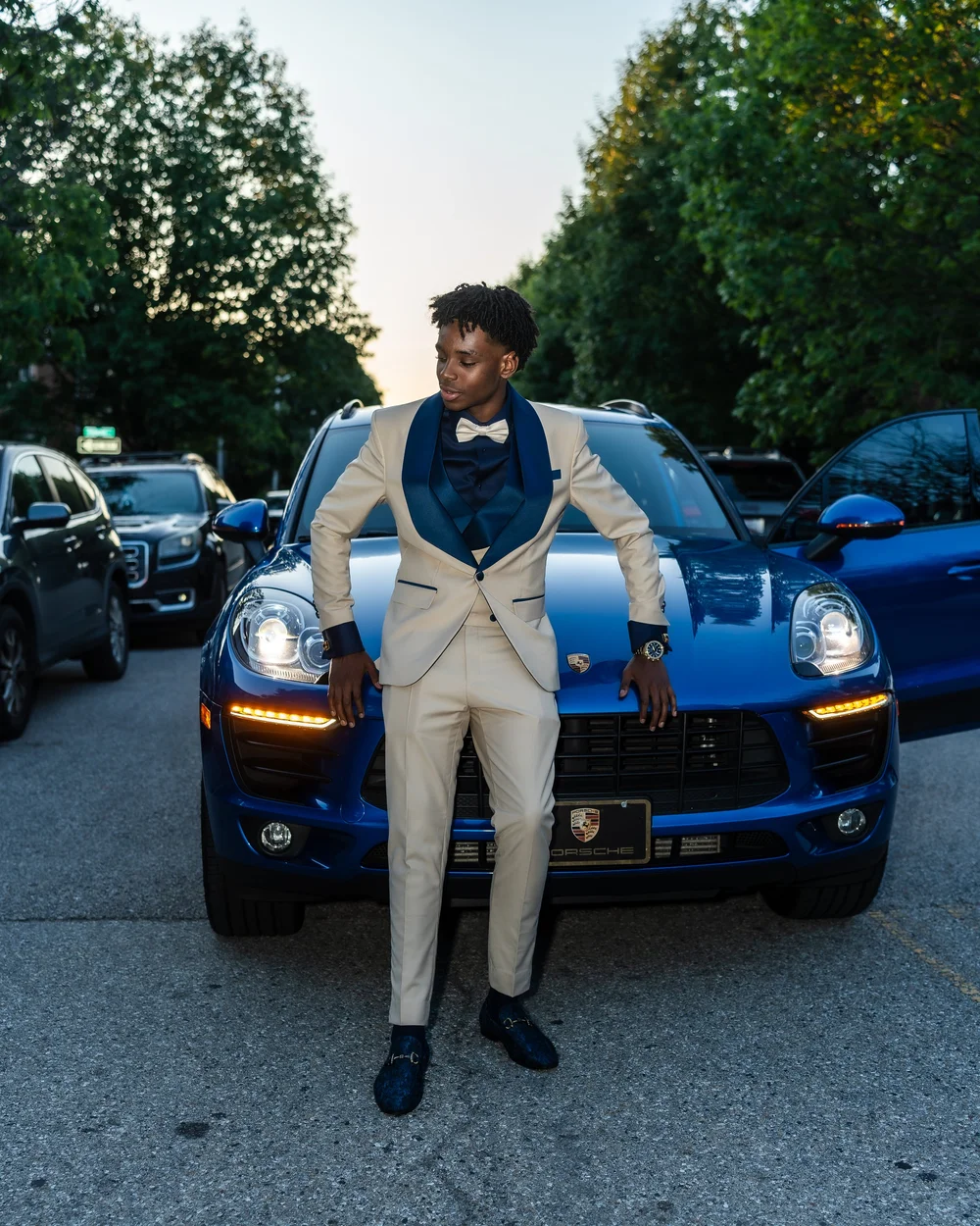 Prom sendoff portrait with a blue sports car