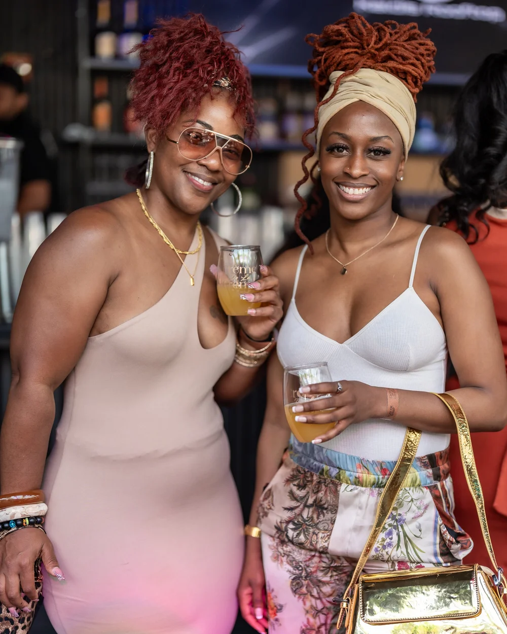Two guests toasting drinks at a rooftop day party
