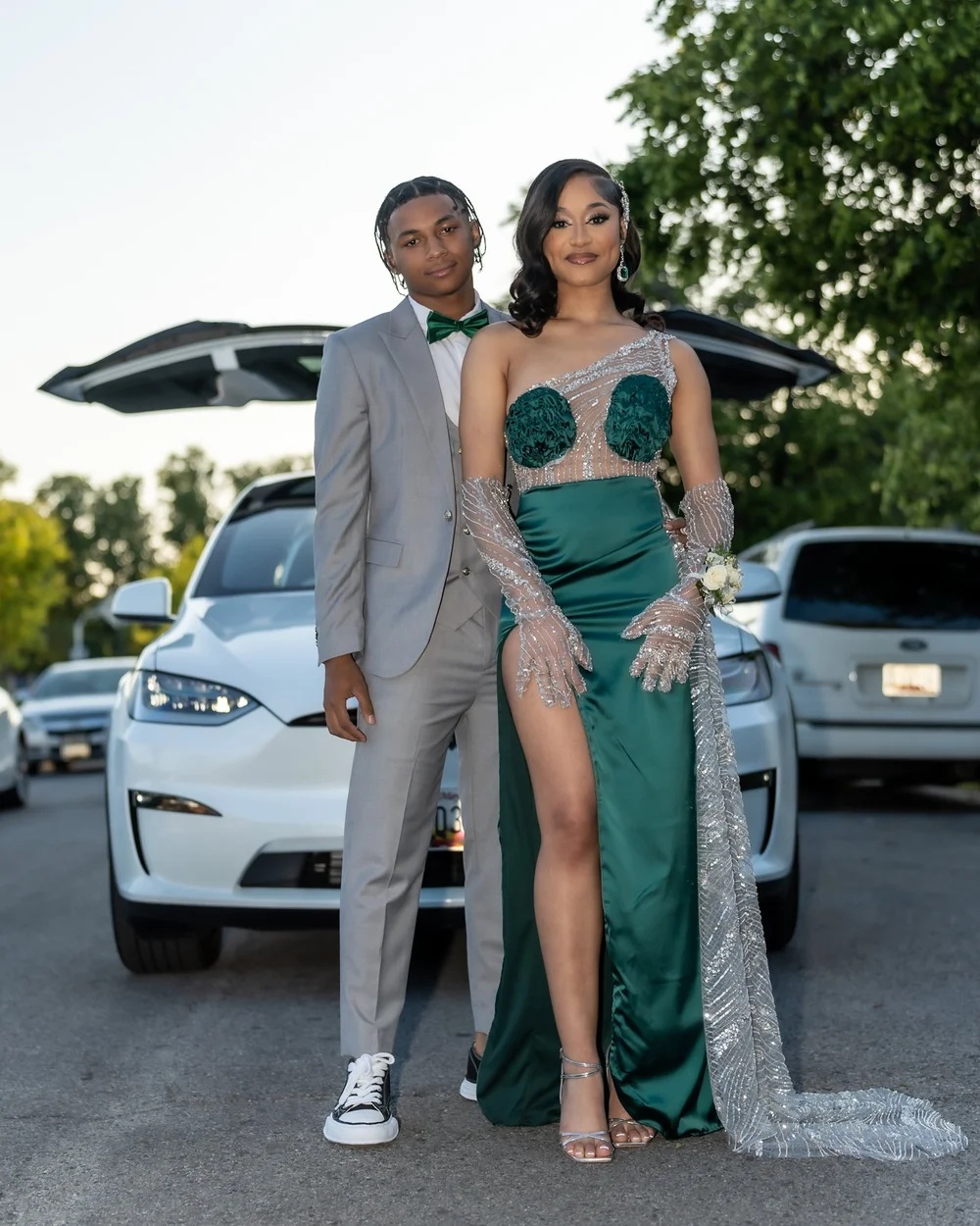 Prom sendoff in a green dress beside a car
