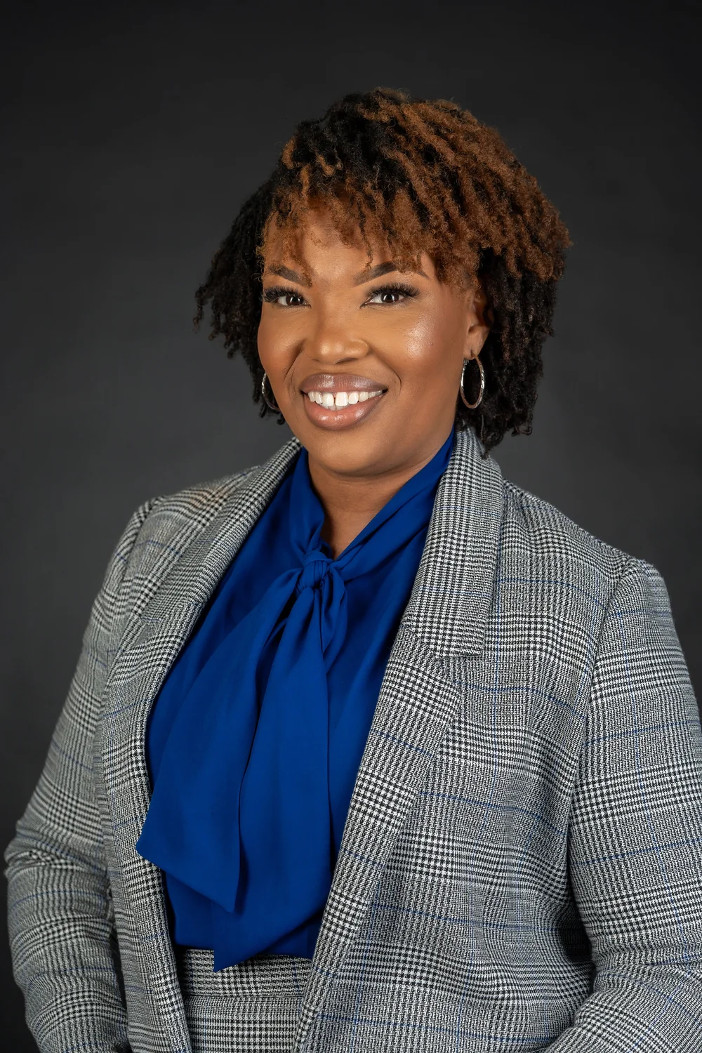 Professional business headshot portrait of a woman in a blue blazer, by Marcus Gregory Photography